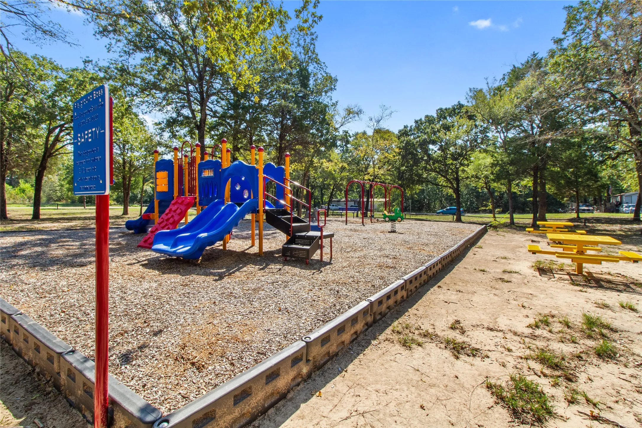 Playground area featuring multiple slides, swings, and a spring rider