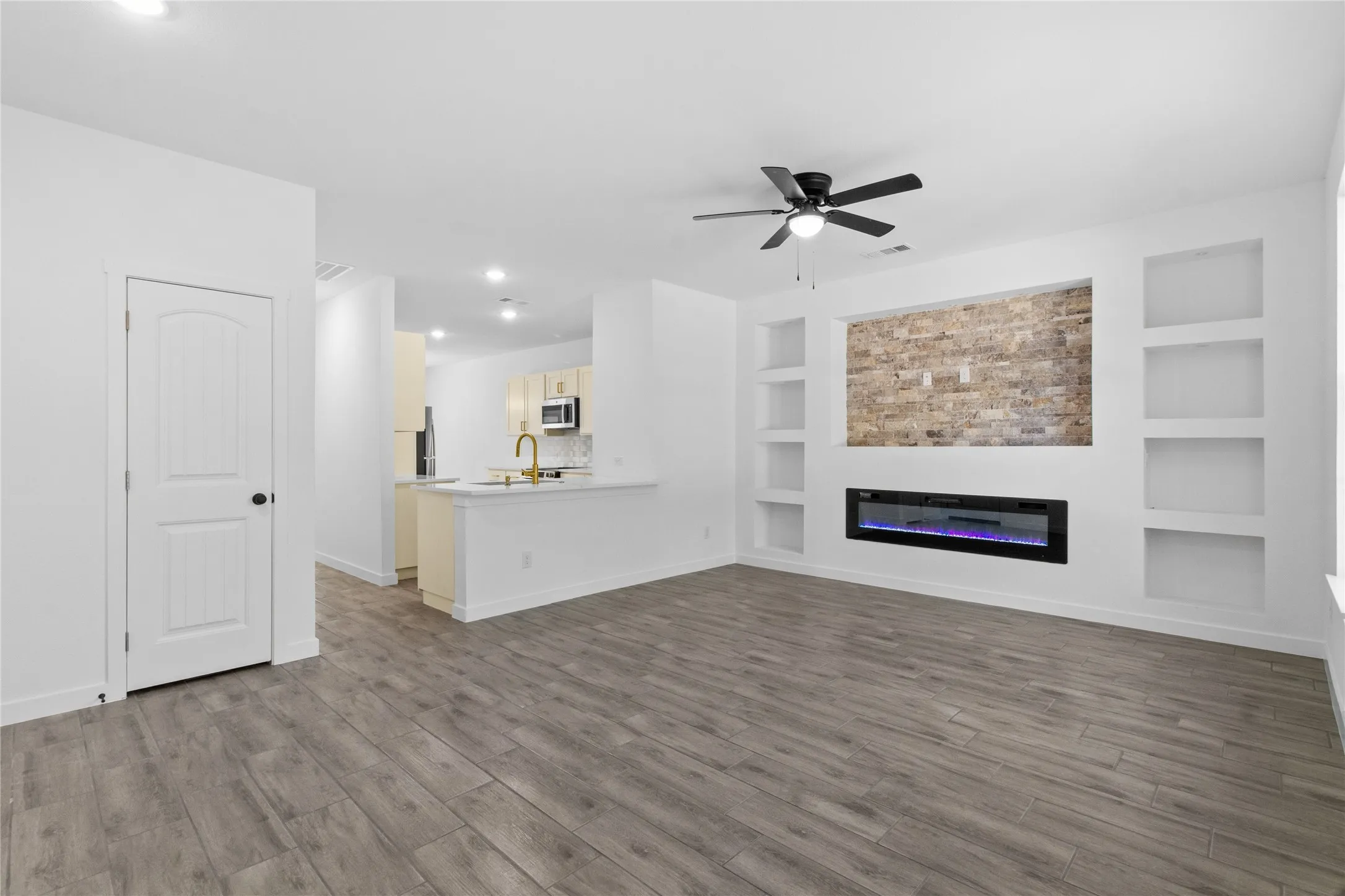 Open-concept living space with wood-finish flooring