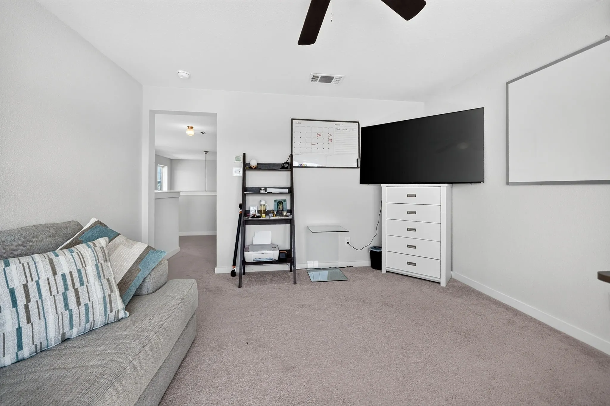 Neutral-toned wall-to-wall carpeting throughout