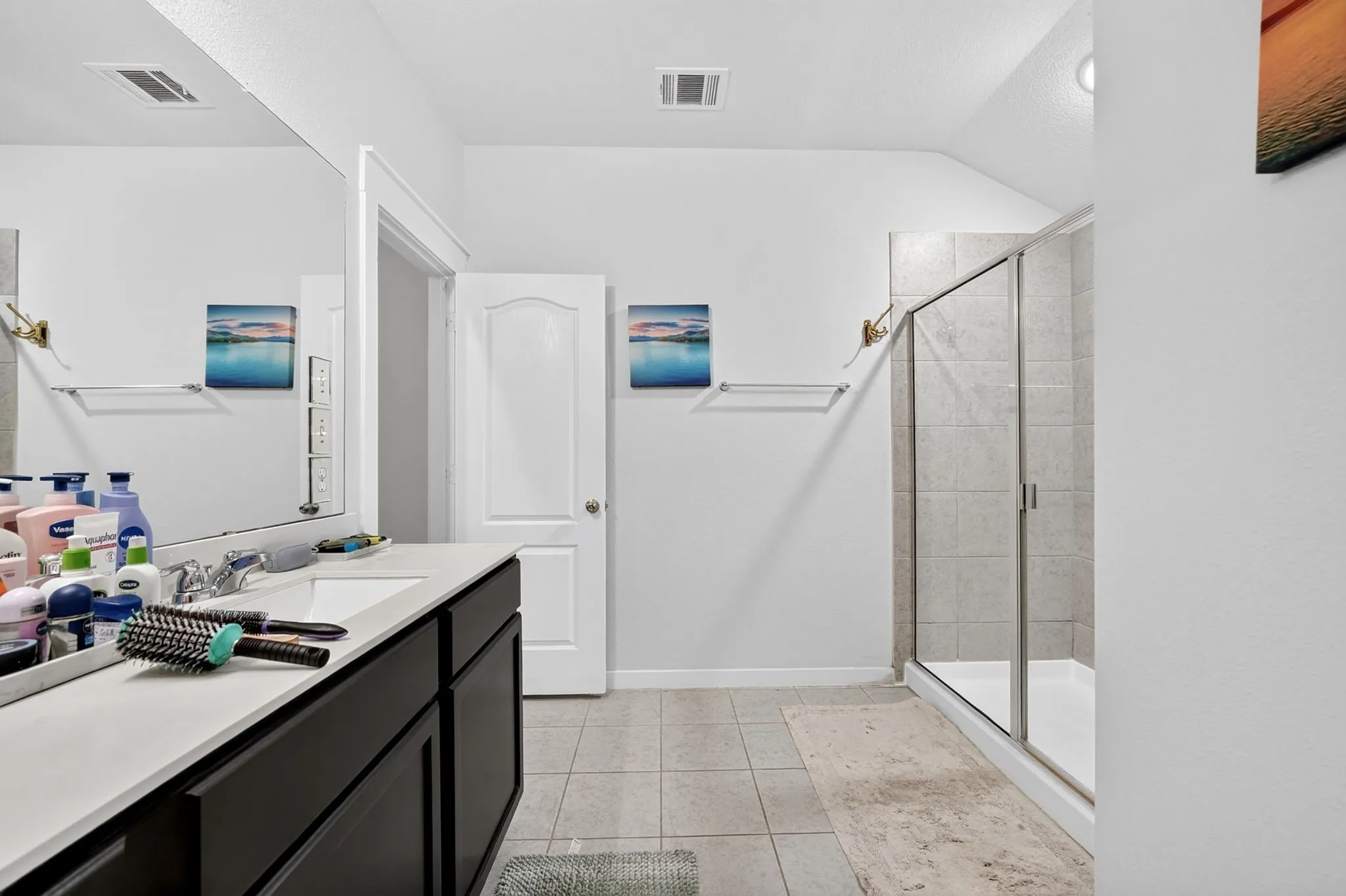 Light gray wall paint, white trim, paneled interior doors, and gray carpet flooring