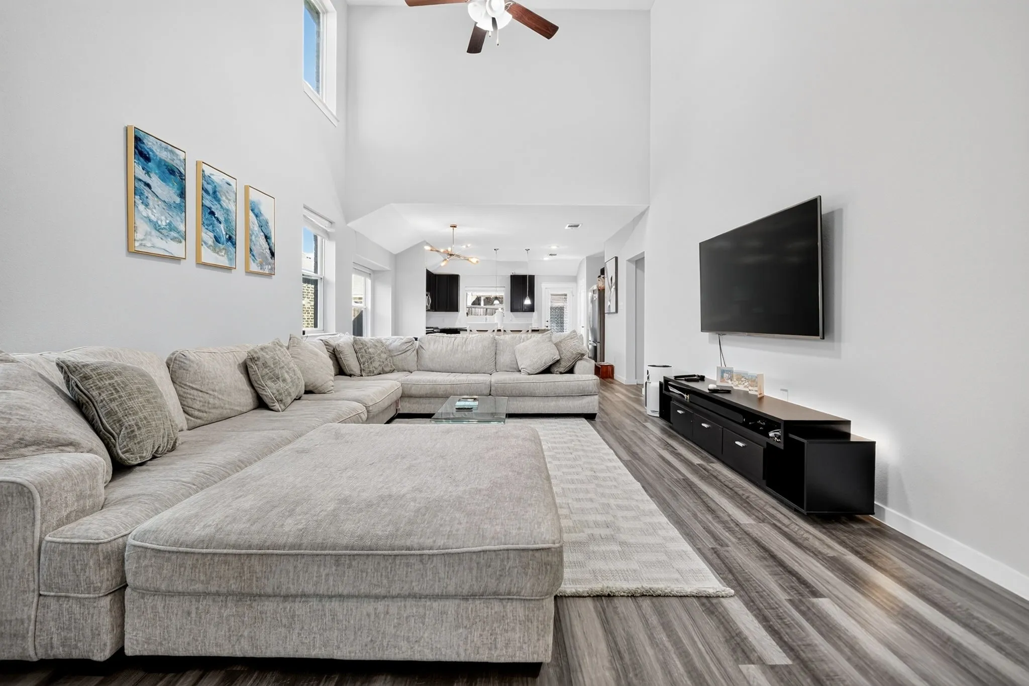 Vaulted ceilings, wood-finish flooring, and a ceiling fan