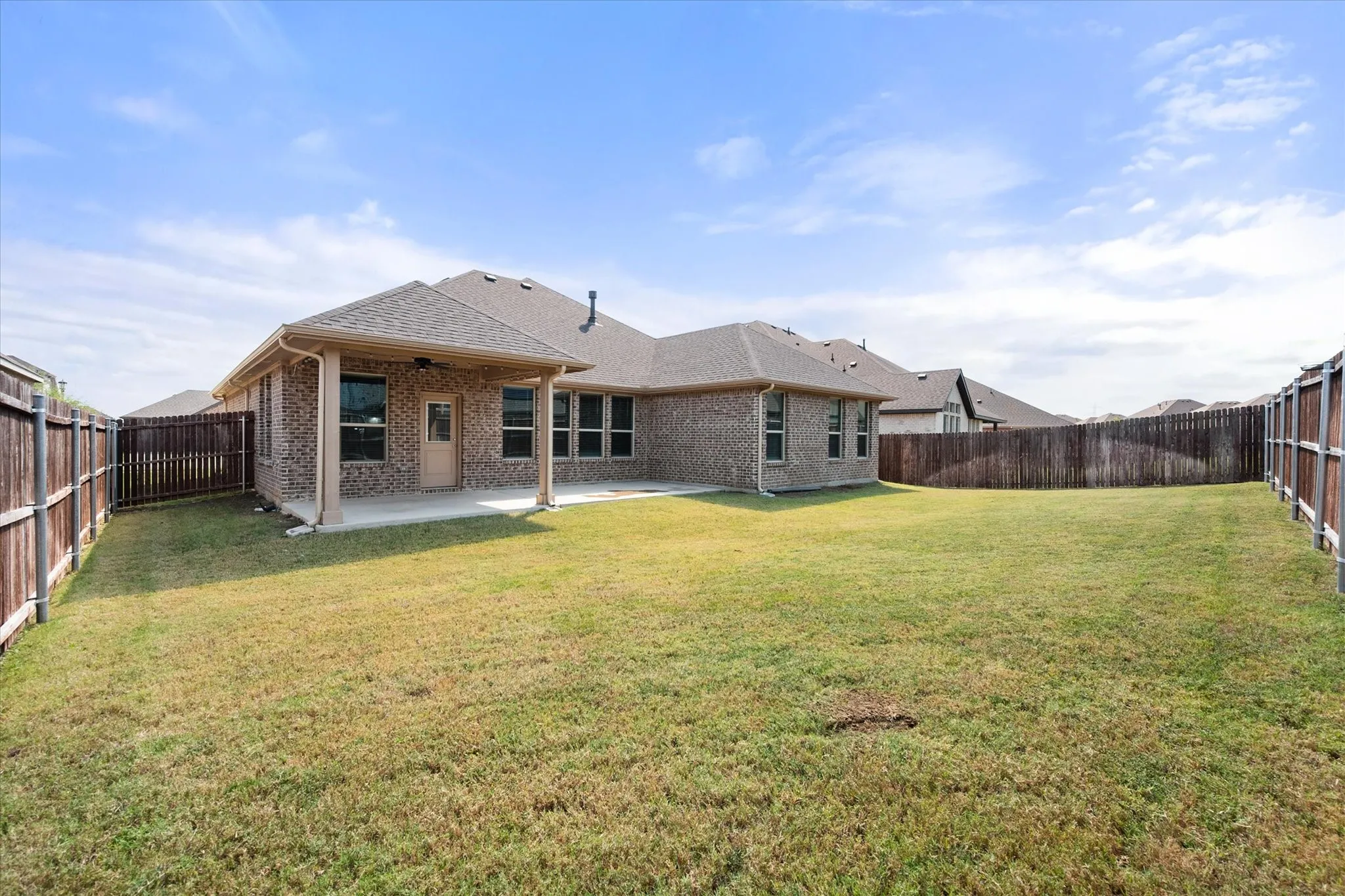 Expansive backyard with a covered patio and homeowner extende