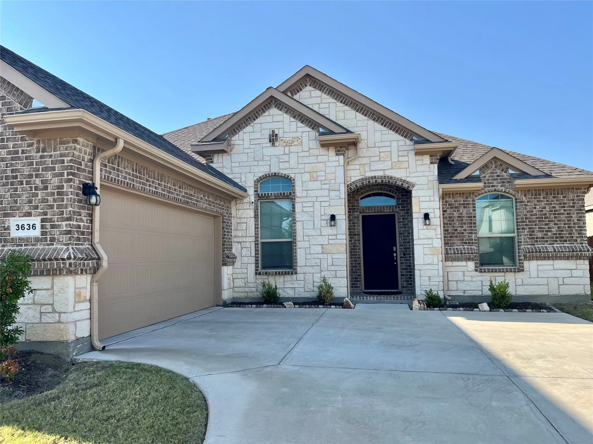 Striking stone and brick exterior with arched entryways and decorative quoins