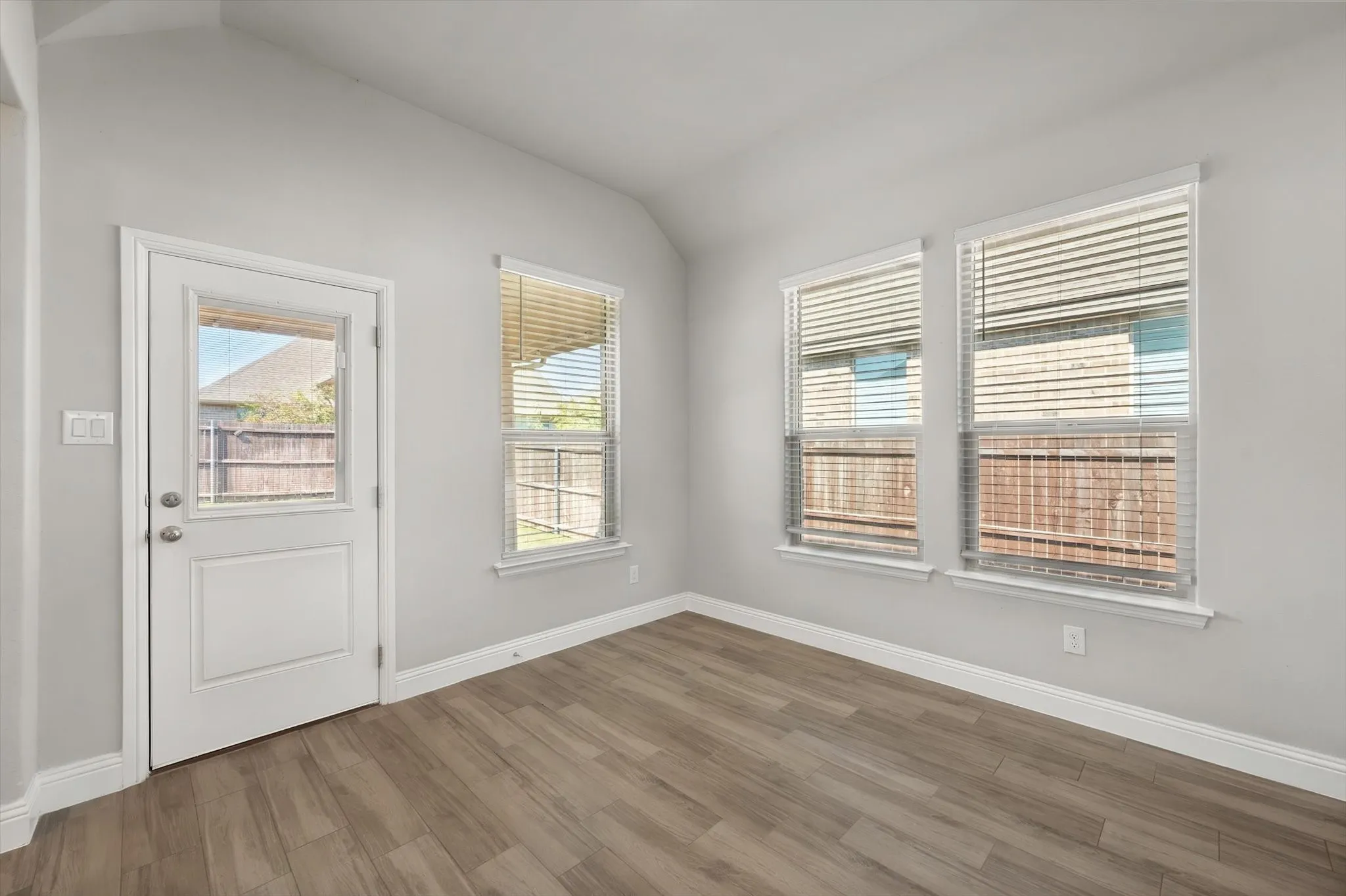 Bright breakfast area flooded with natural light through multiple casement windows