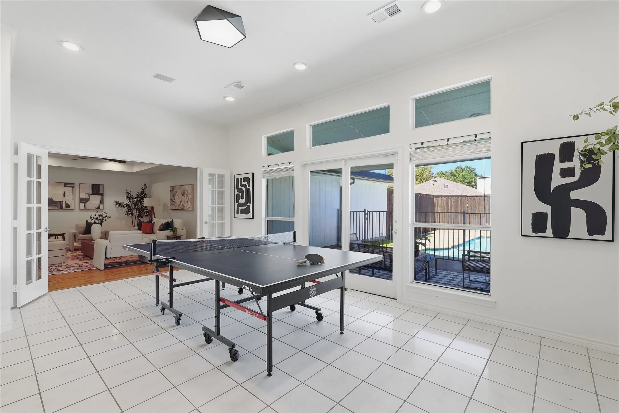 White tile flooring throughout, recessed lighting, and a contemporary ceiling fixture