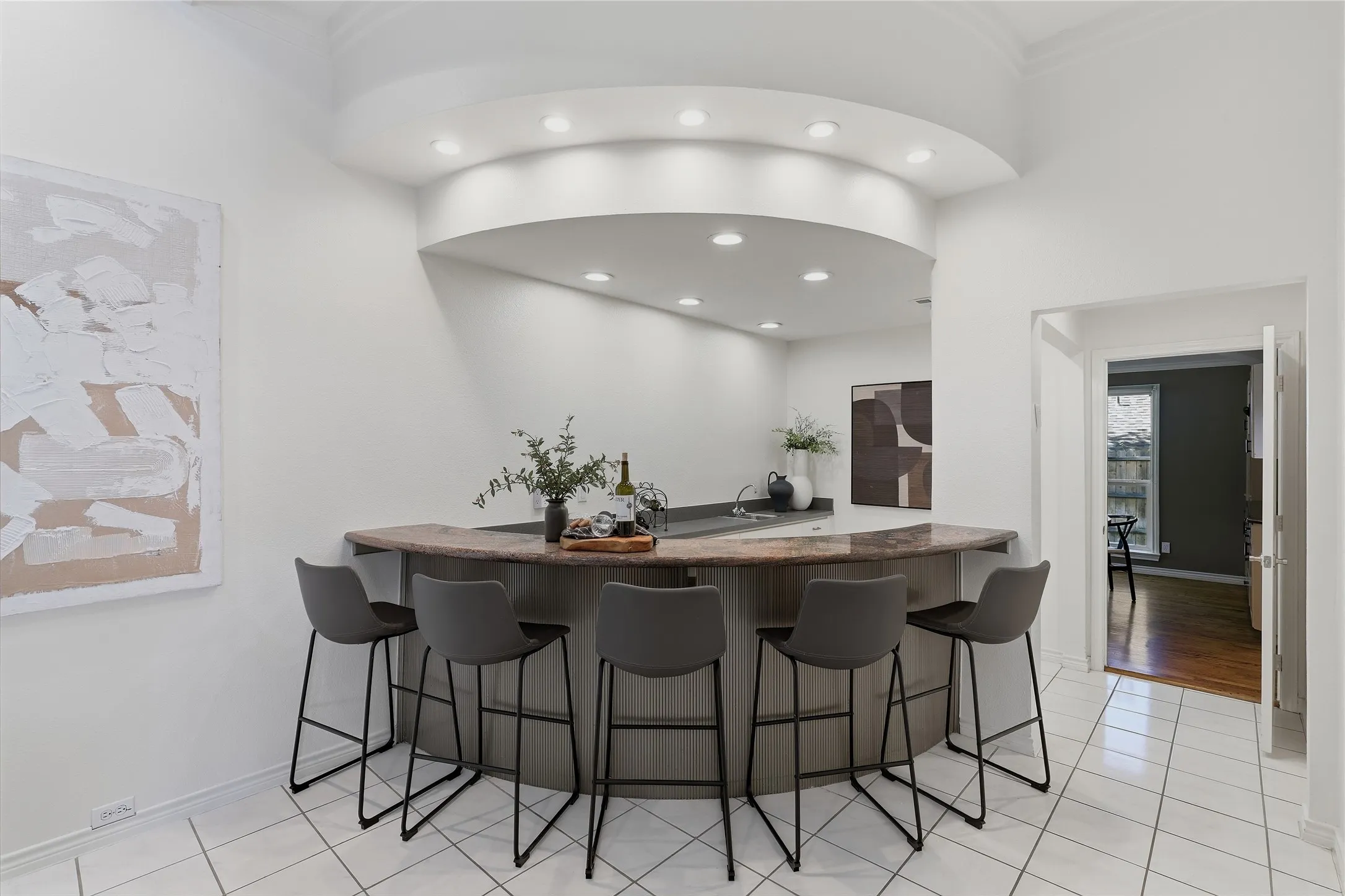 Built-in bar with a stone countertop, recessed lighting, and tile flooring