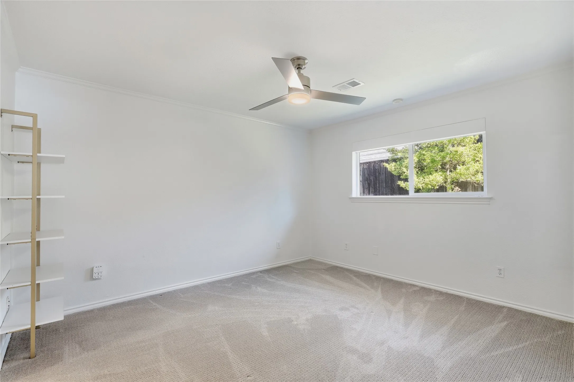 Recessed lighting, ceiling fan with integrated light, built-in shelving, carpet flooring, window with natural light