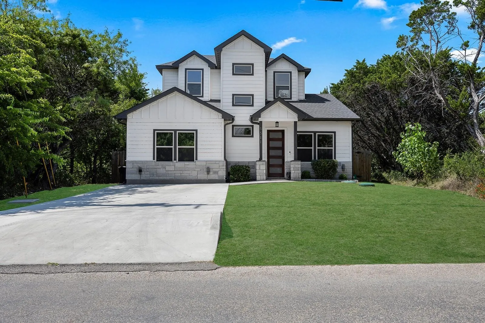 Modern two-story residence featuring a clean-lined architectural design with gabled rooflines and multiple peaked sections