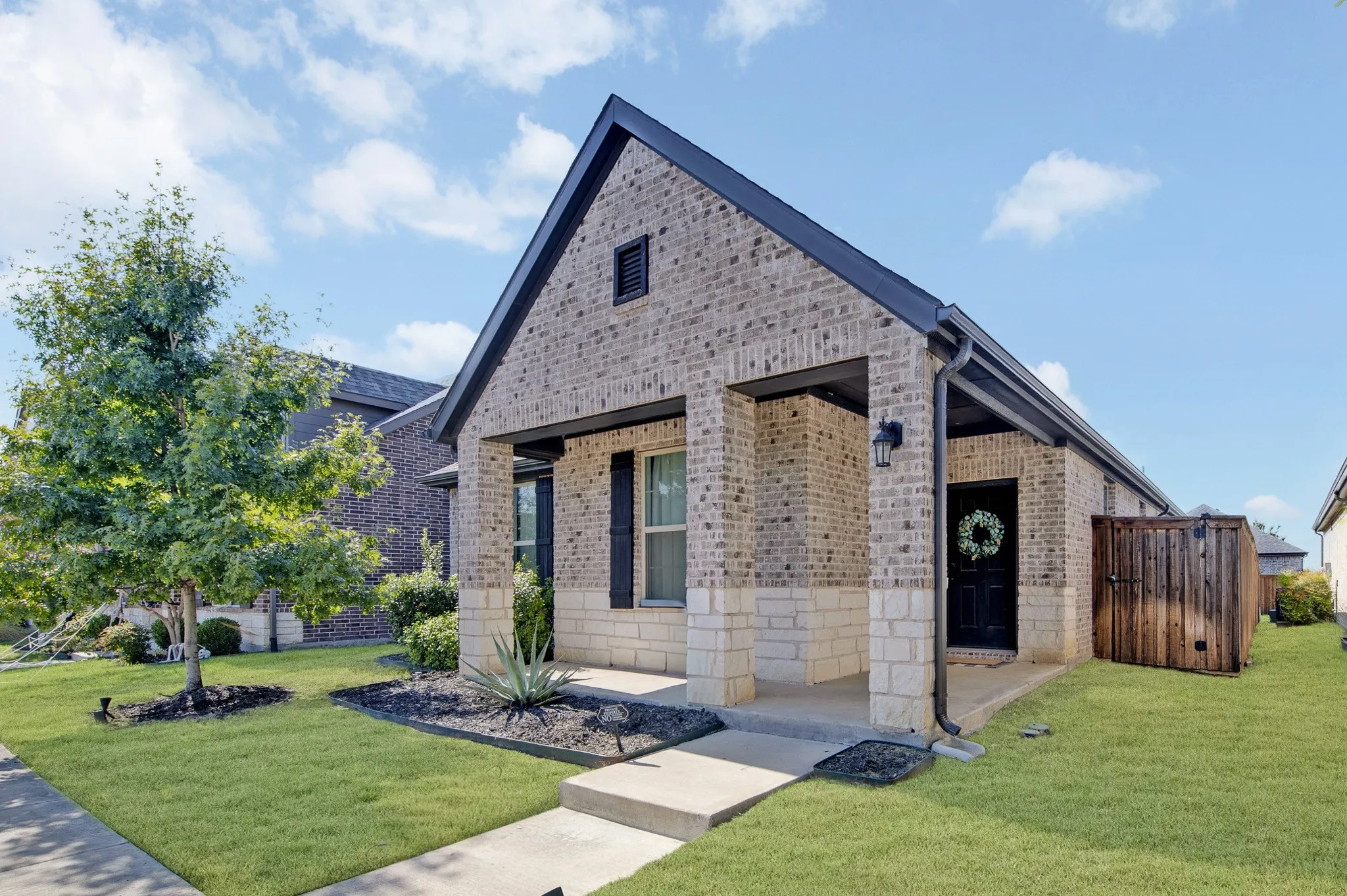 Charming brick cottage with clean architectural lines and a gabled roofline