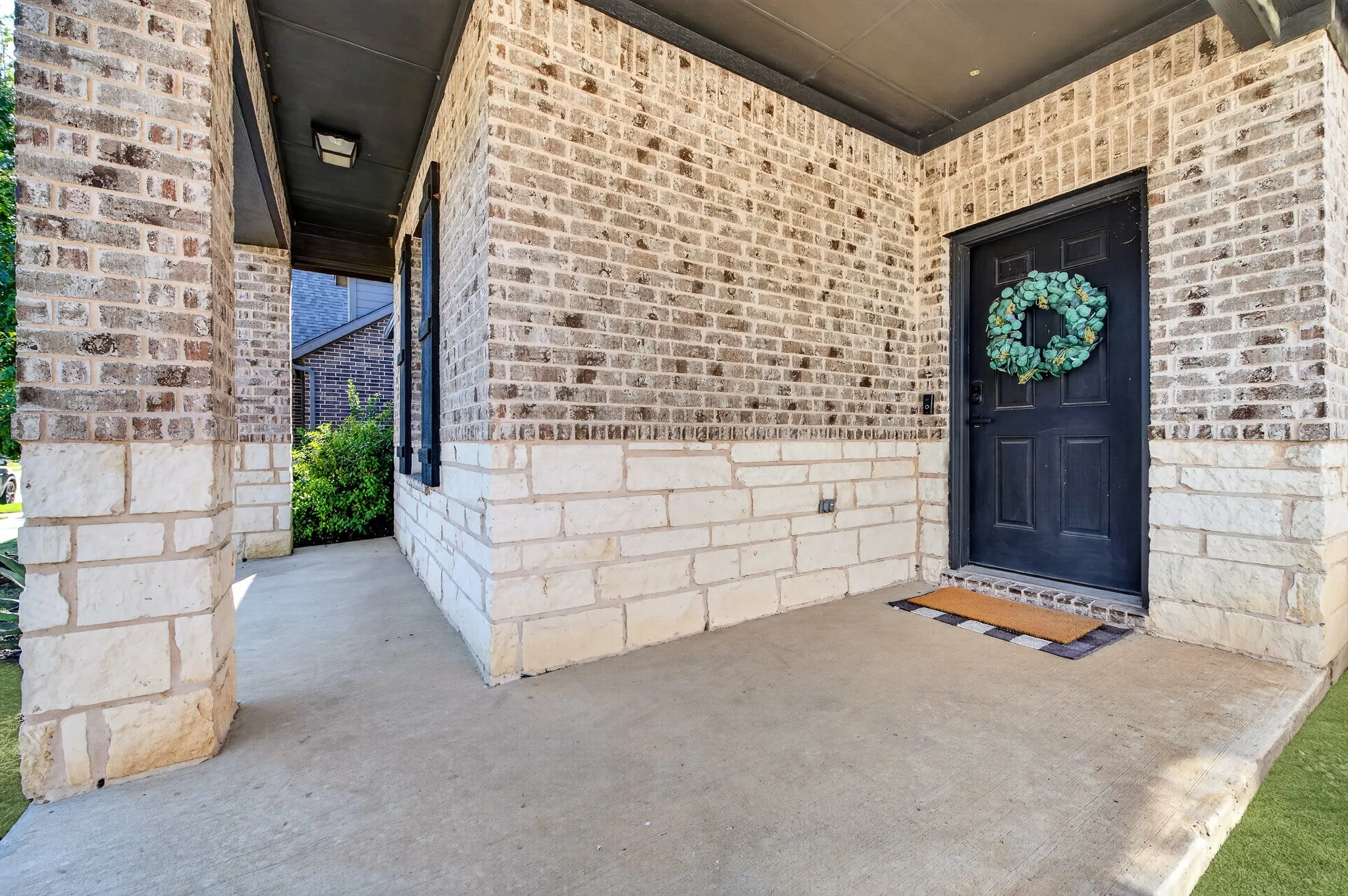 Brick and stone exterior with a covered entry