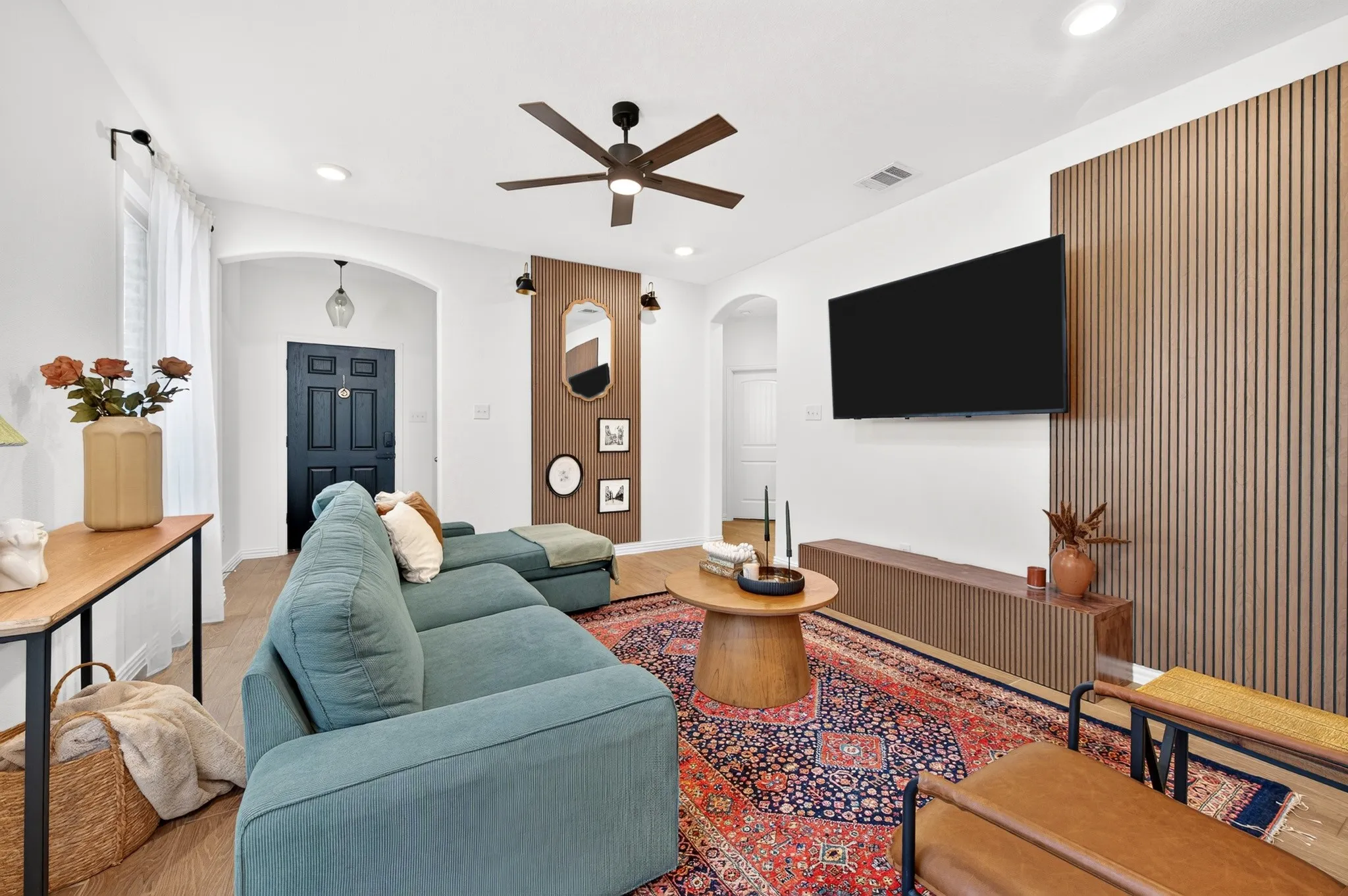 Wood-finish flooring, recessed lighting, and a dark-toned ceiling fan