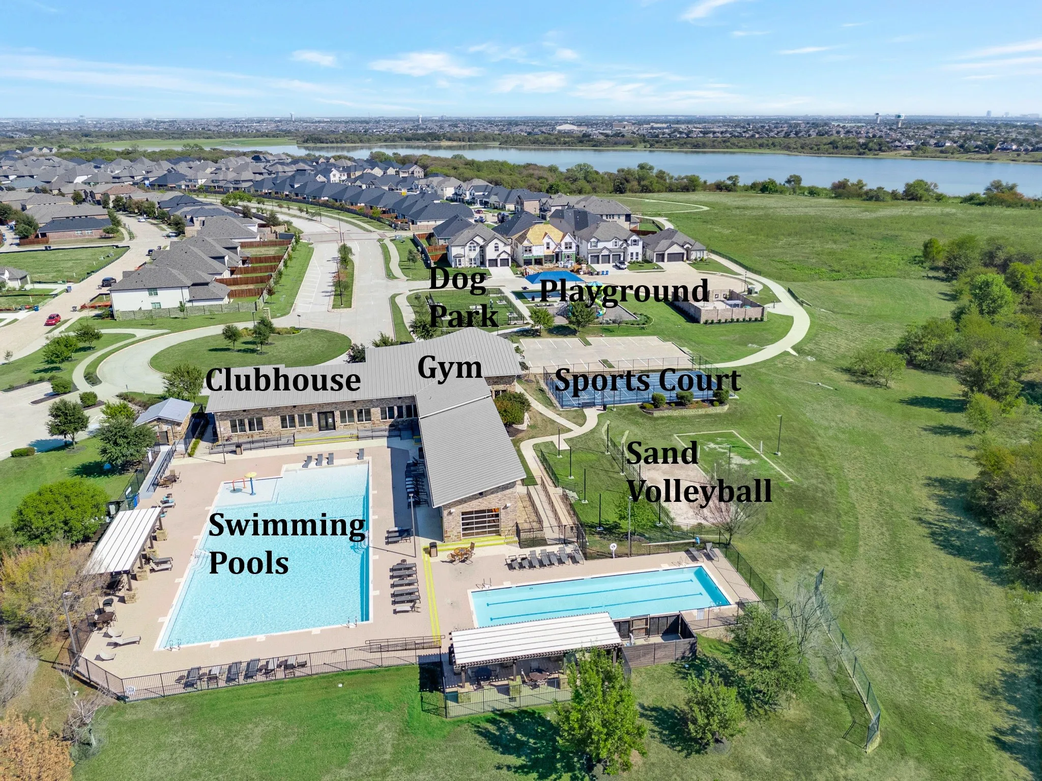 Clubhouse with multiple swimming pools, sports court, and sand volleyball