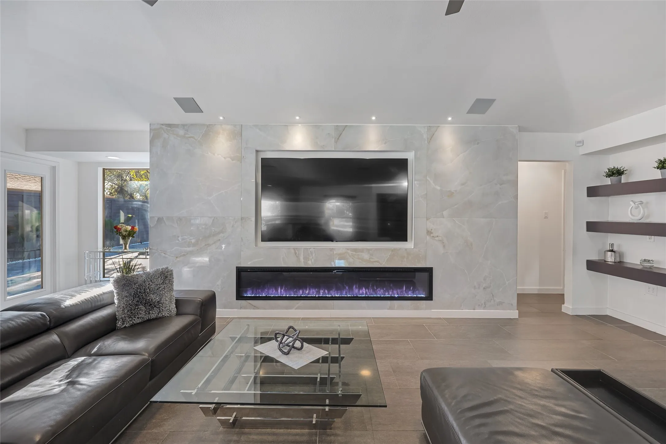 Marble-look accent wall with an integrated linear electric fireplace