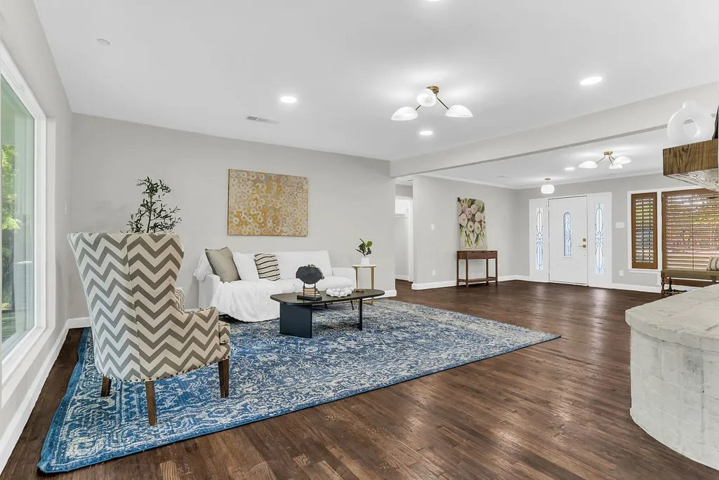 Living area open to the entry with hardwood floors