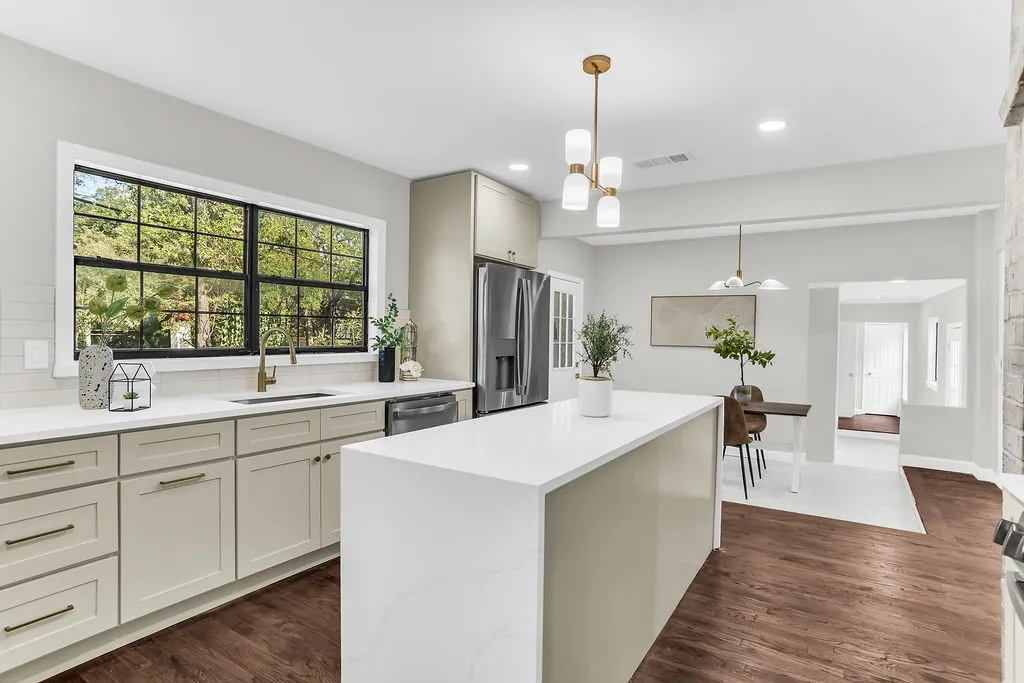 Sink under a large picture window overlooking the trees