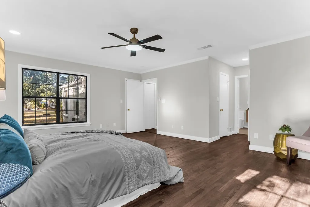 Primary bedroom with ceiling fan and walk-in closet access
