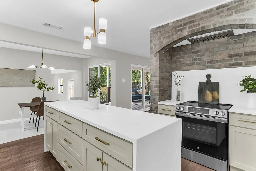 Range set into a full-height original brick archway with vent hood