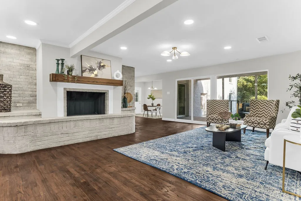 Floor-to-ceiling brick fireplace with reclaimed-wood mantel and curved raised hearth