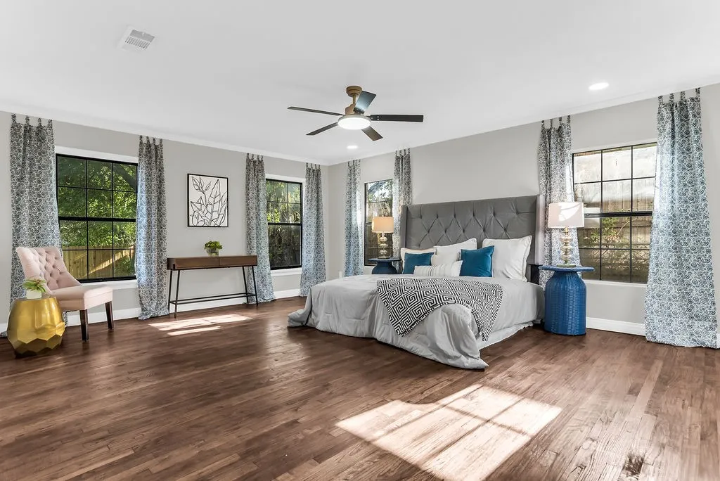 Main-floor primary bedroom with windows on three walls