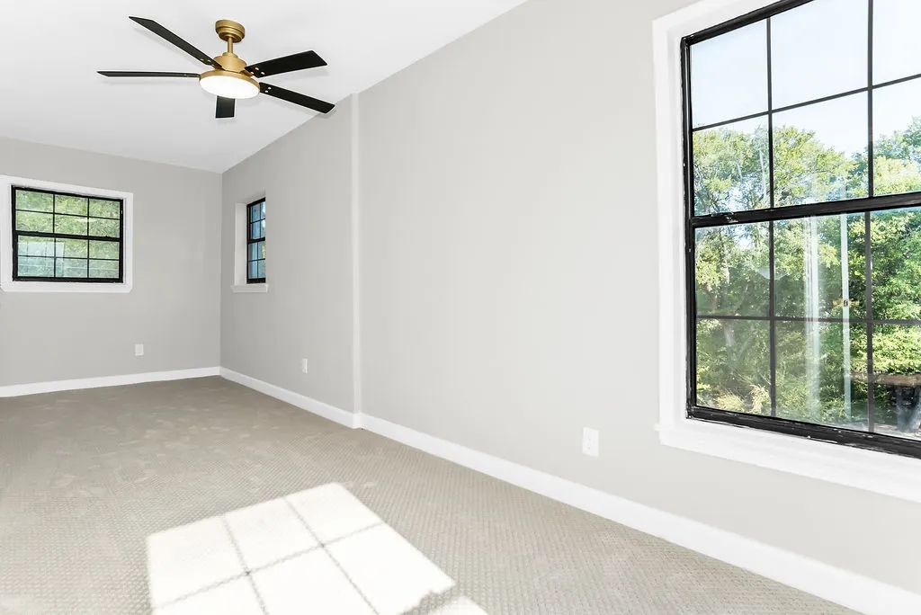 Upstairs family room with carpet and large windows