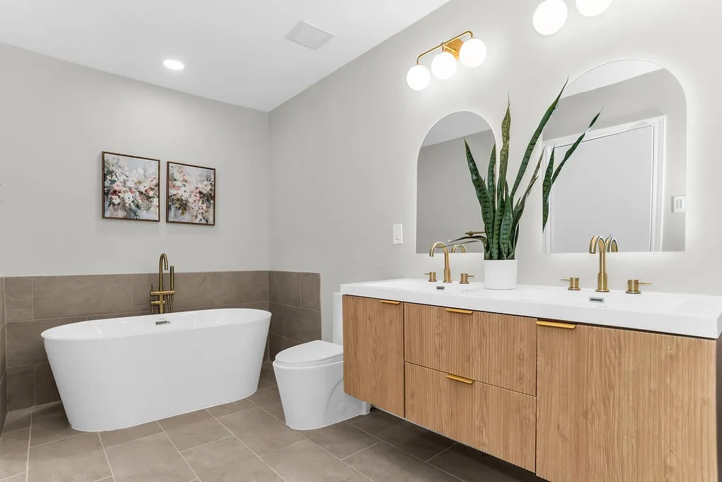 Primary bath with freestanding soaking tub and floating double vanity
