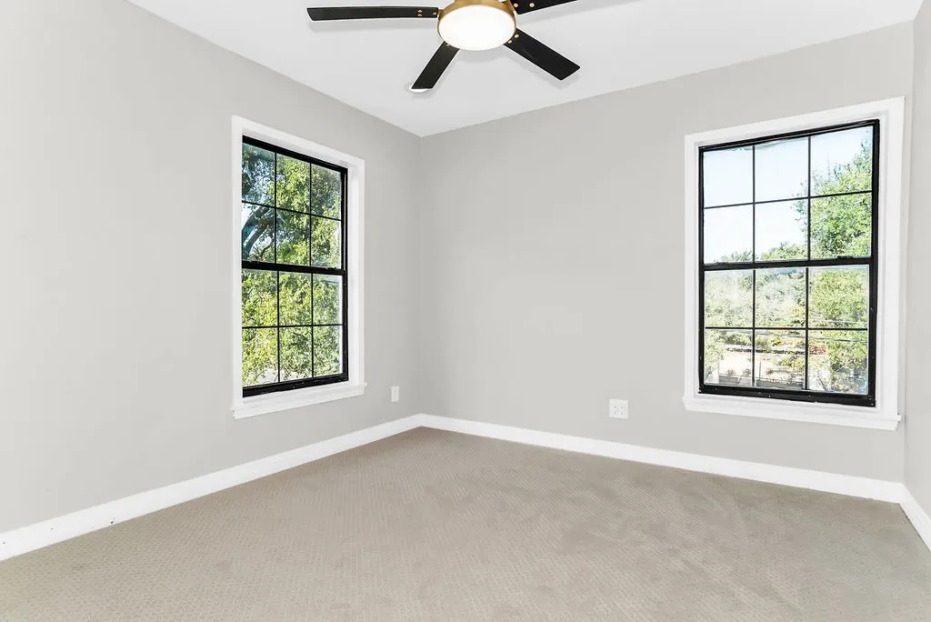 Upstairs room with carpet and ceiling fan