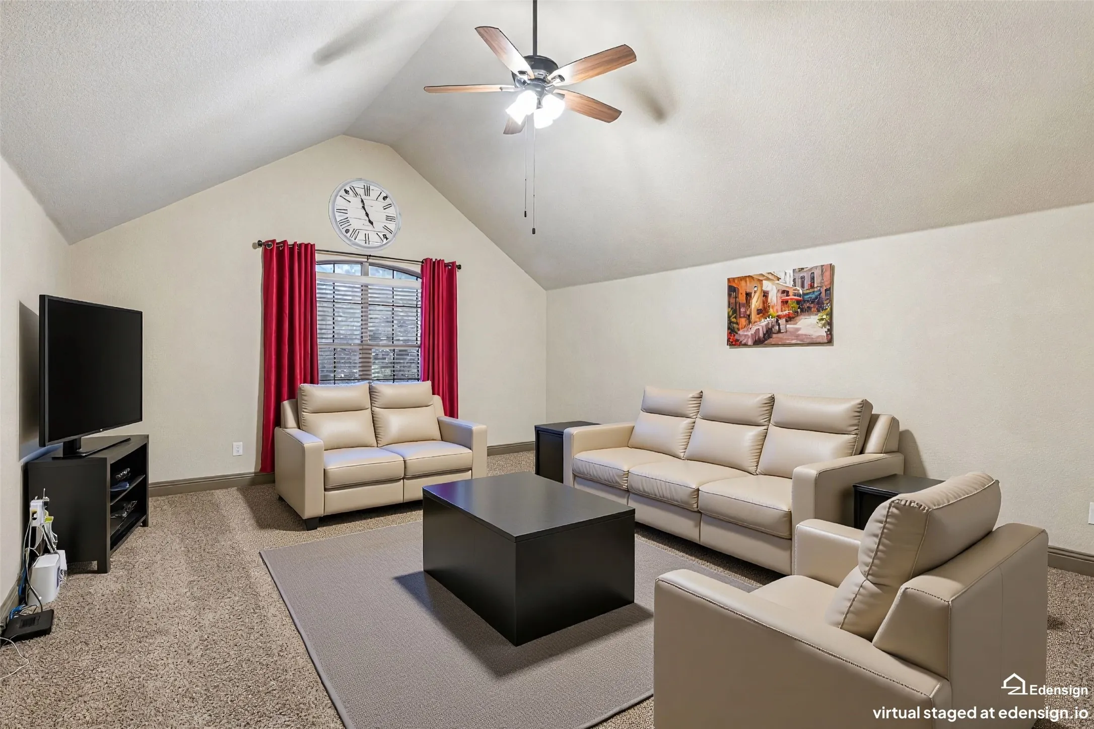 Spacious recreation room showcasing vaulted ceilings with ceiling fan, arched architectural alcoves, neutral carpeting, and black cube-form coffee table. Virtually Staged.