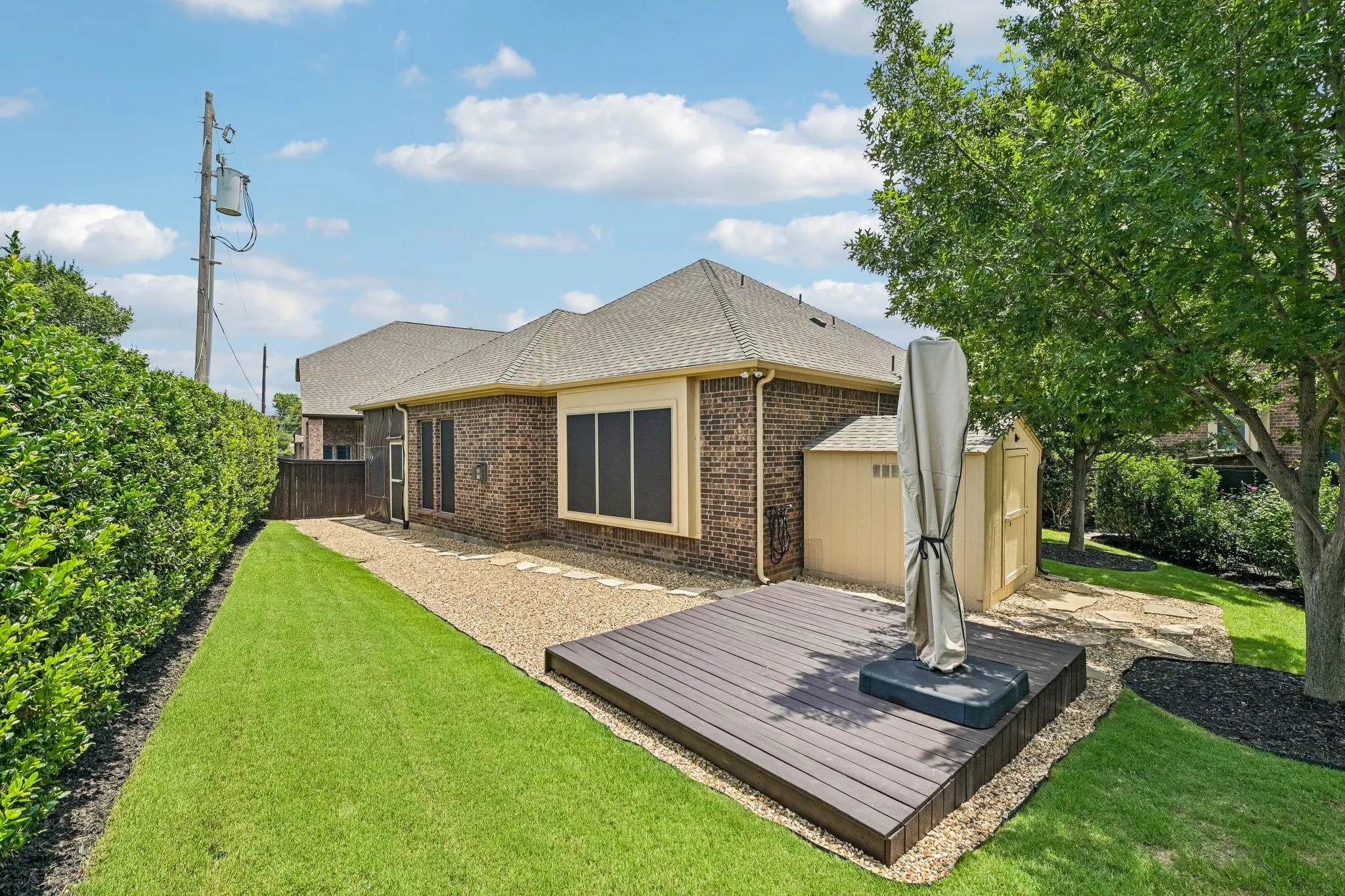 Brick exterior with a gabled roof and rain gutters