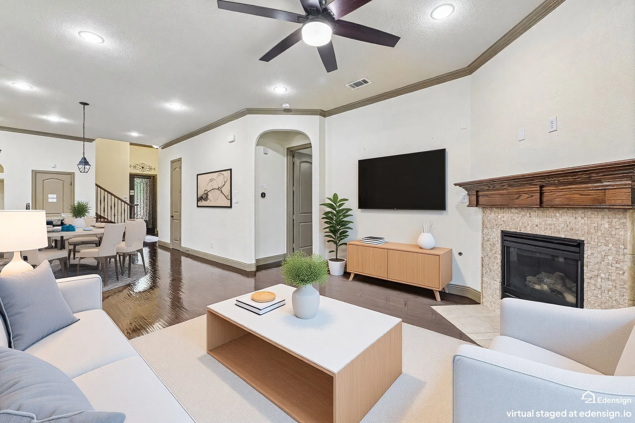 Vaulted ceiling with a ceiling fan, arched window, and carpet flooring