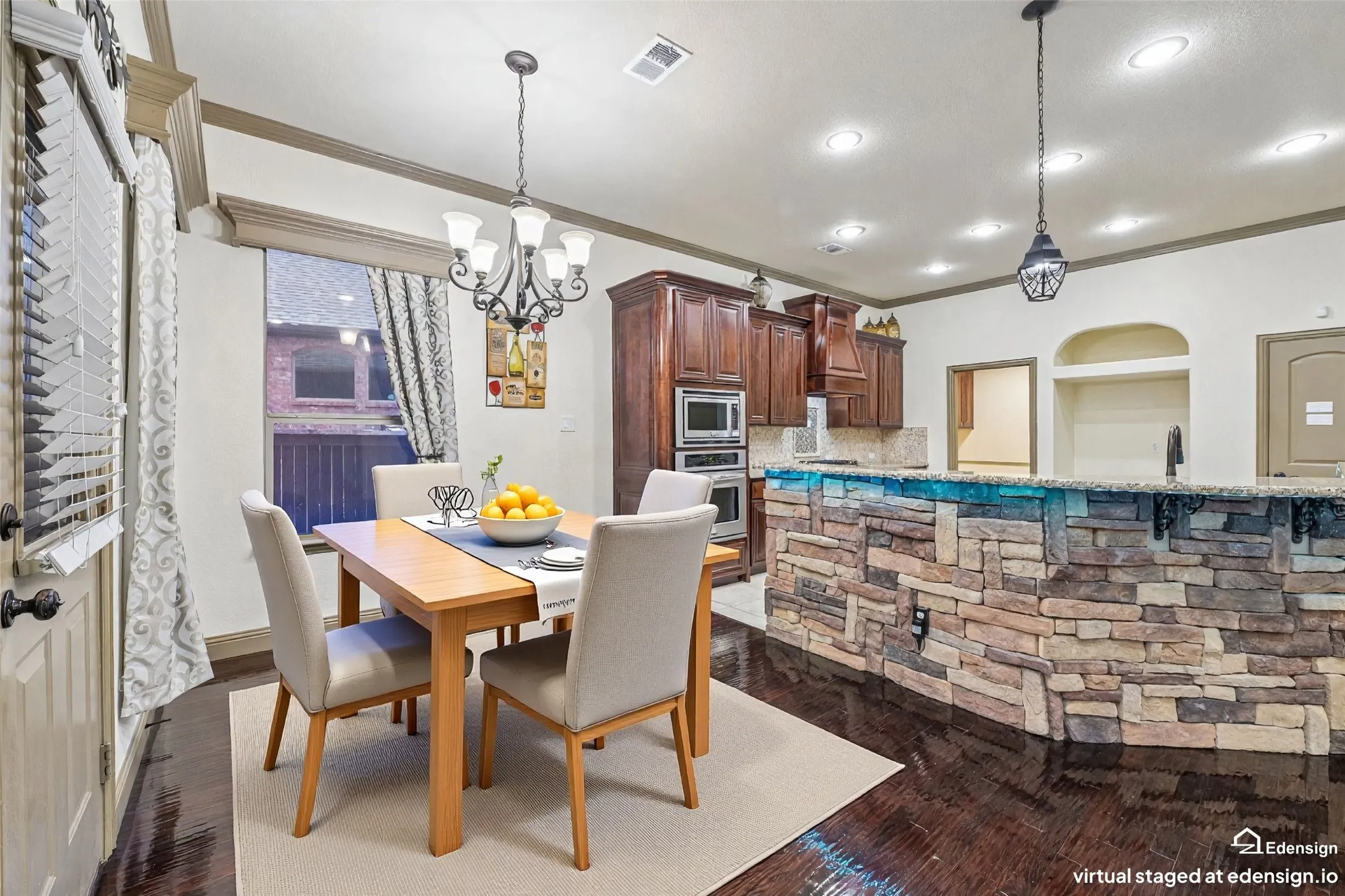 Bright dining area showcasing a wood-finish table with seating for four, pendant lighting fixture, and large windows dressed with patterned curtains. Virtually Staged.