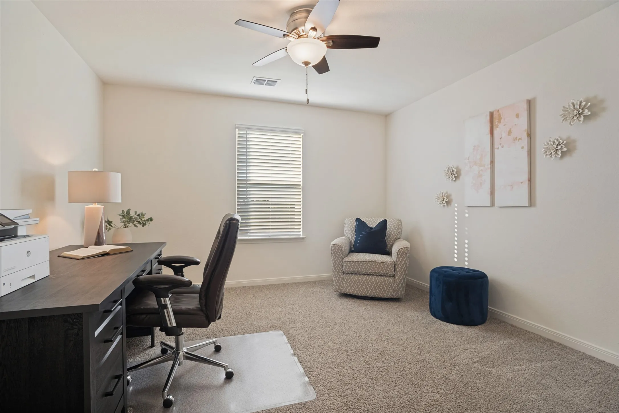 Room featuring neutral wall tones, carpeted flooring, a single window with blinds, and a ceiling fan with integrated lighting