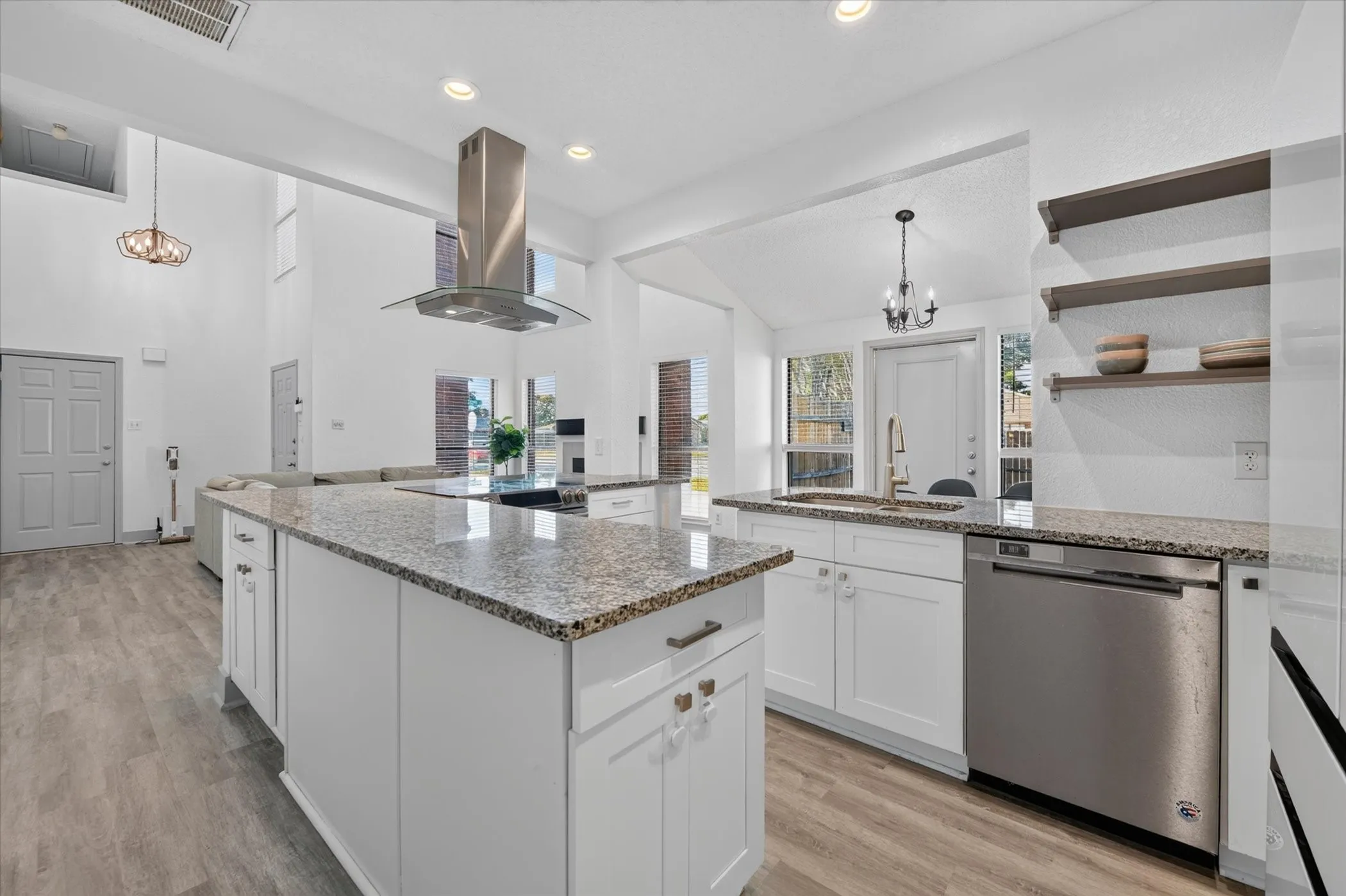 The kitchen falso features a dishwsher, disposal, and open shelving that creates a modern feel while adding extra storage.