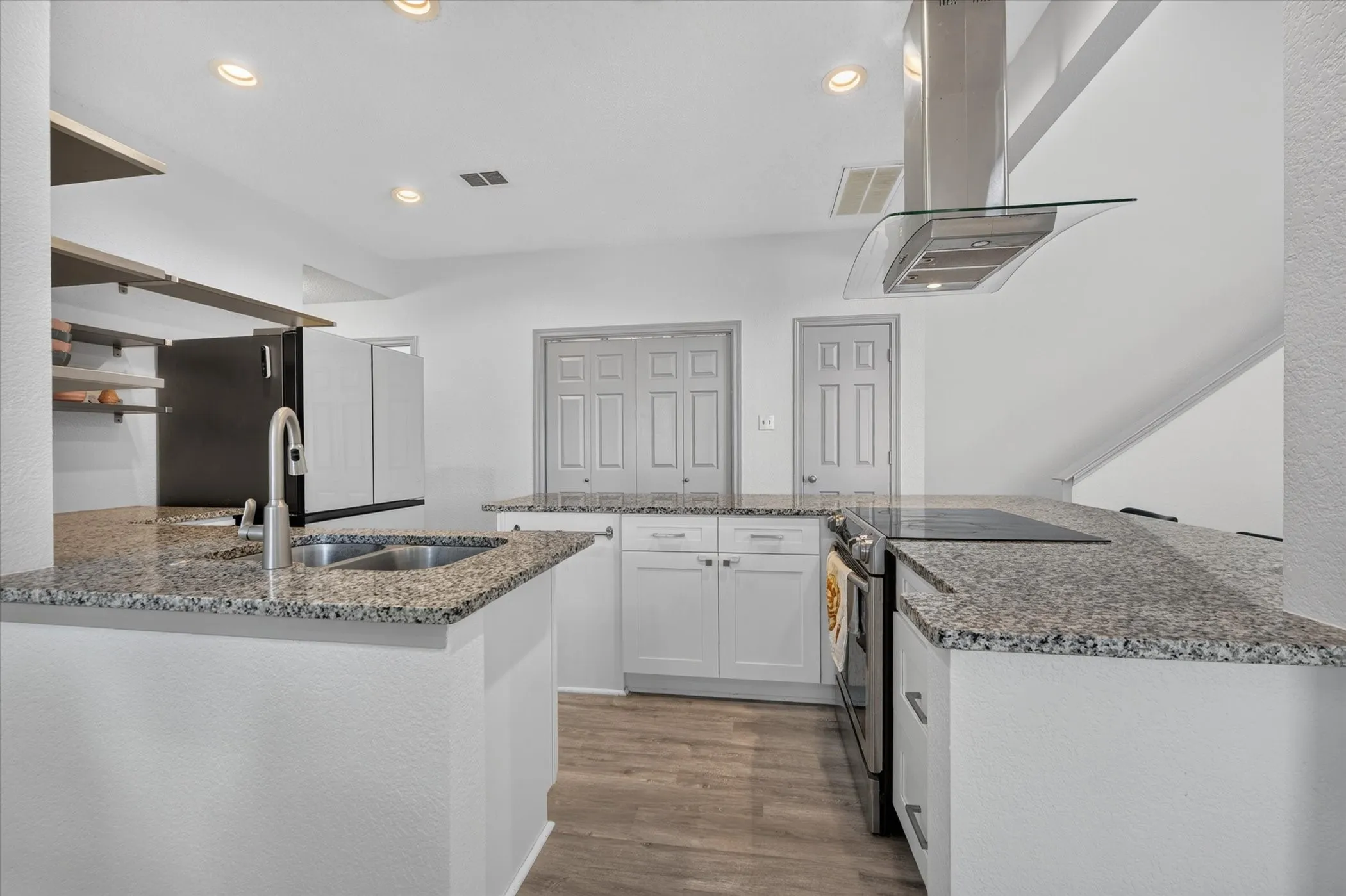 The kitchen features beautiful granite countertops, abundant cabinet storage, and an open layout that blends seamlessly with the dining and living areas.