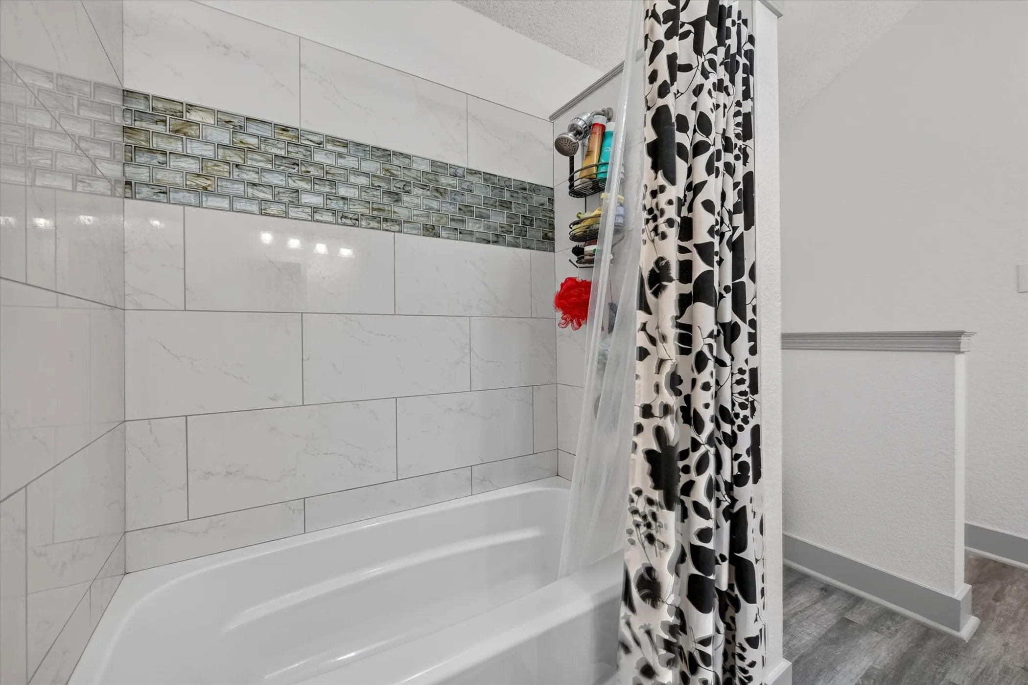 Large primary bathroom with dual vanities and large tub