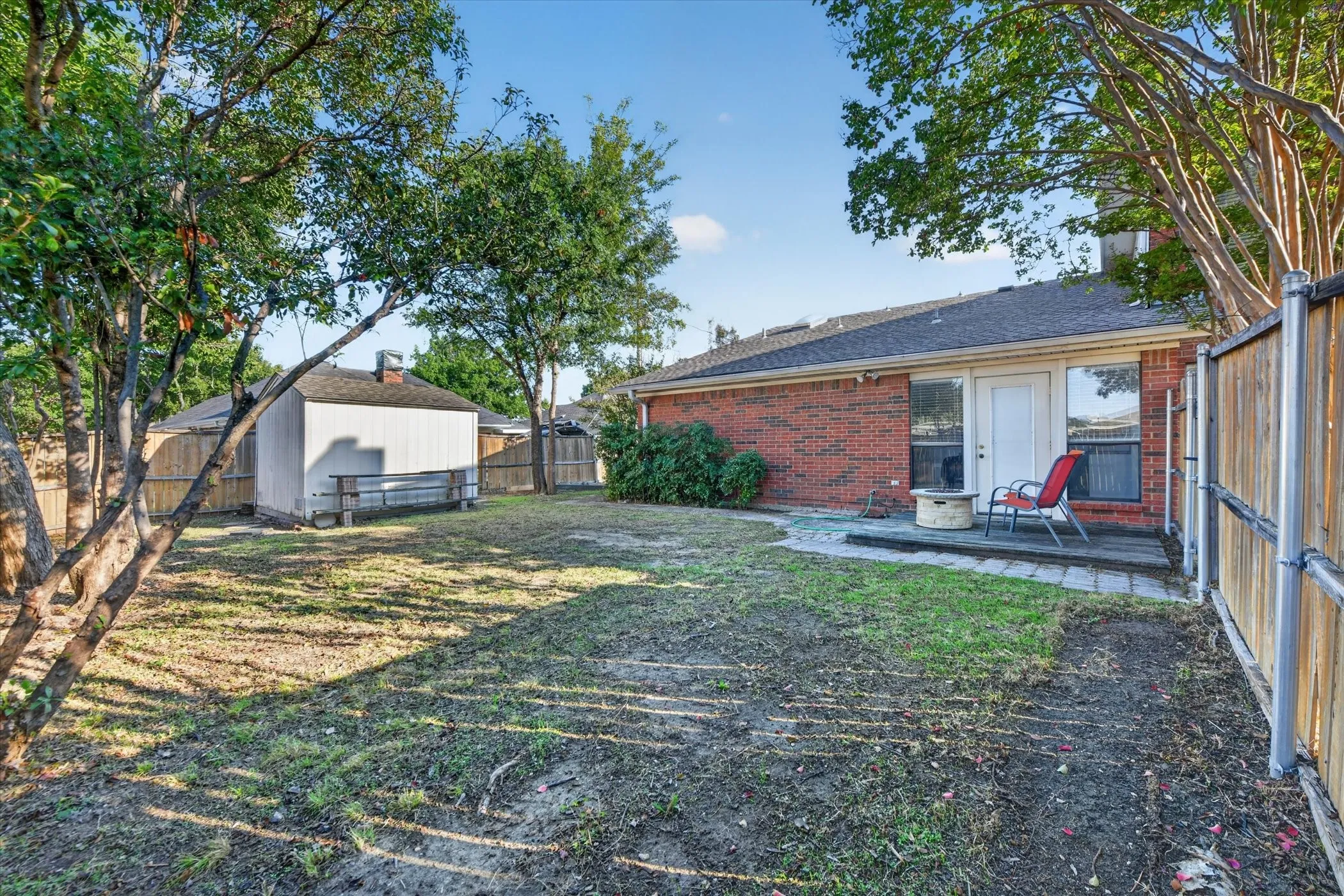 The backyard features a charming deck, offering a cozy outdoor space to relax, enjoy your morning coffee, or unwind in the fresh air.