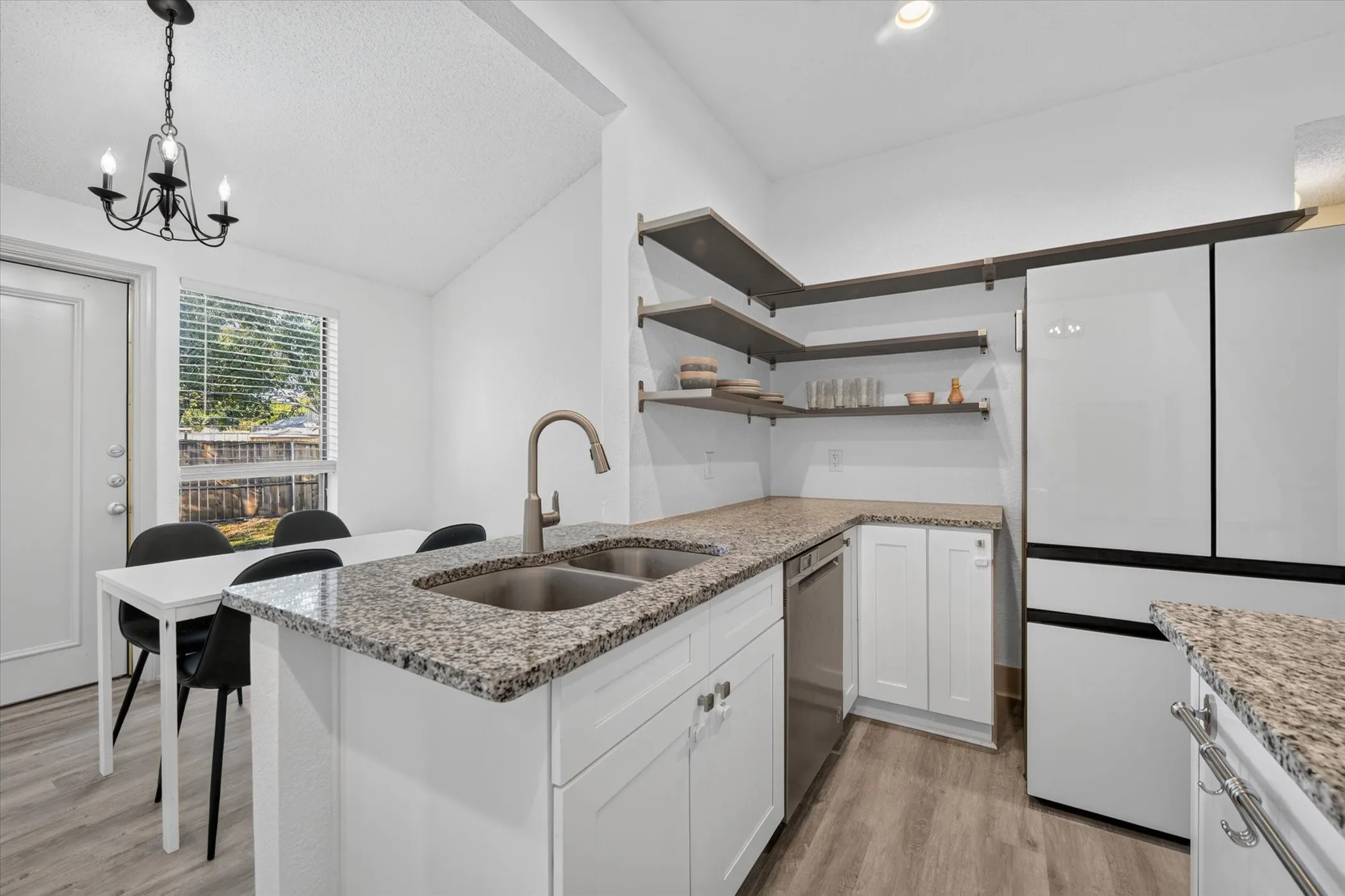The breakfast bar creates a welcoming gathering spot, perfect for quick meals, conversation, and entertaining while staying connected to the kitchen