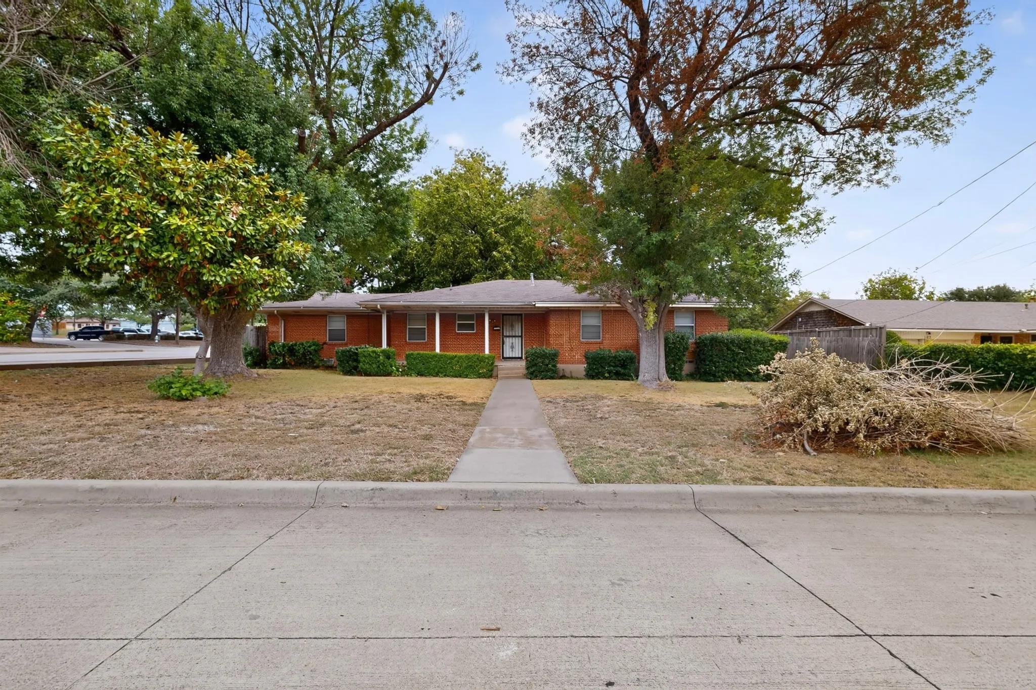 Brick exterior with white columns and a covered porch