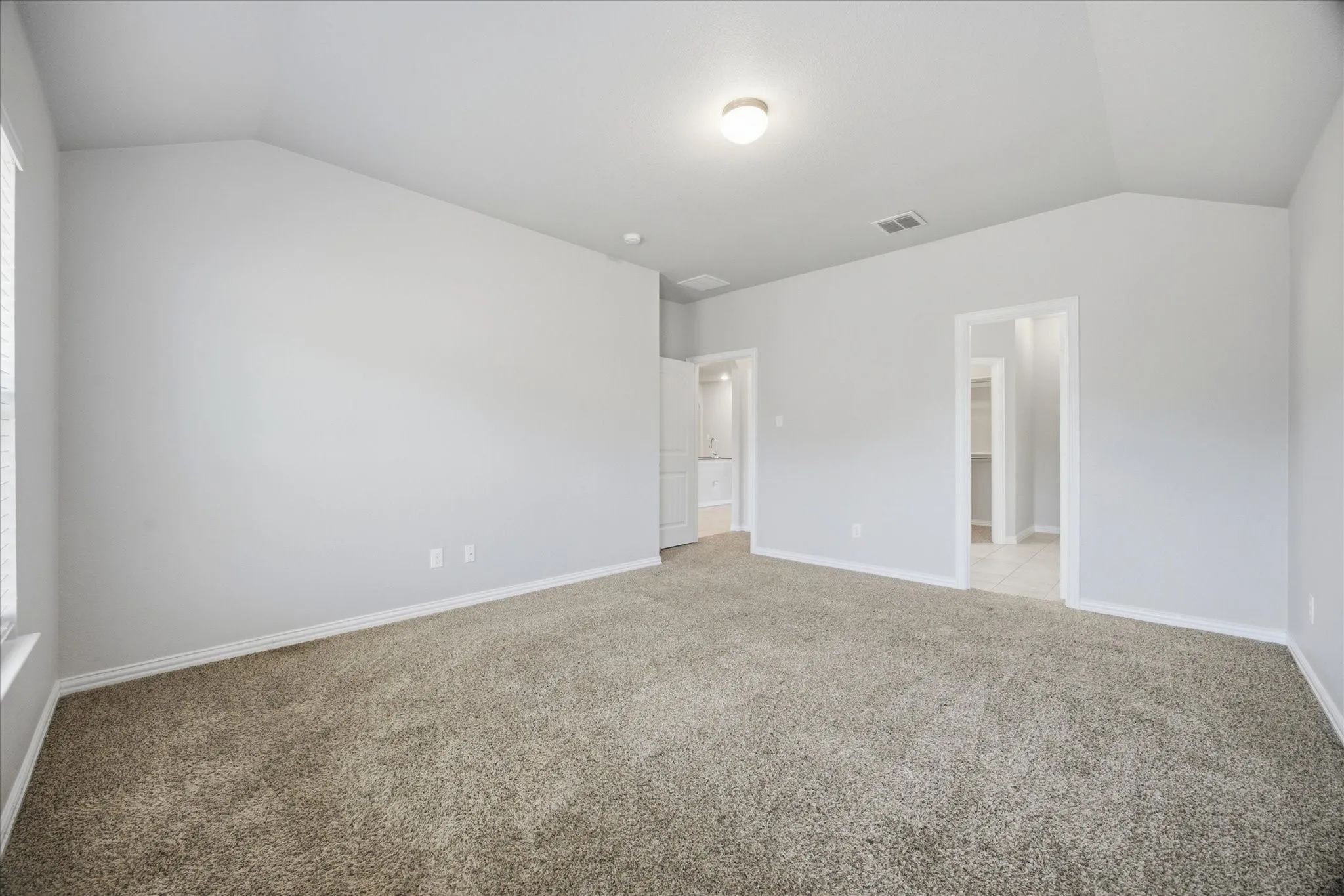 Vaulted ceiling, neutral wall paint, carpeted flooring, window with blinds, and recessed lighting