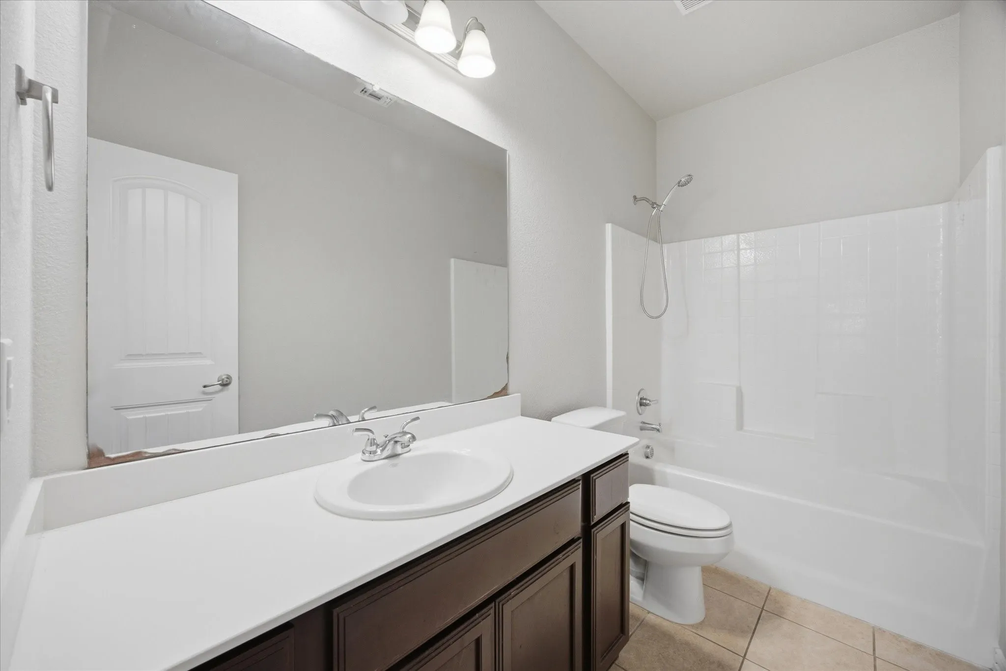 Vanity with white countertop, chrome faucet, and integrated sink