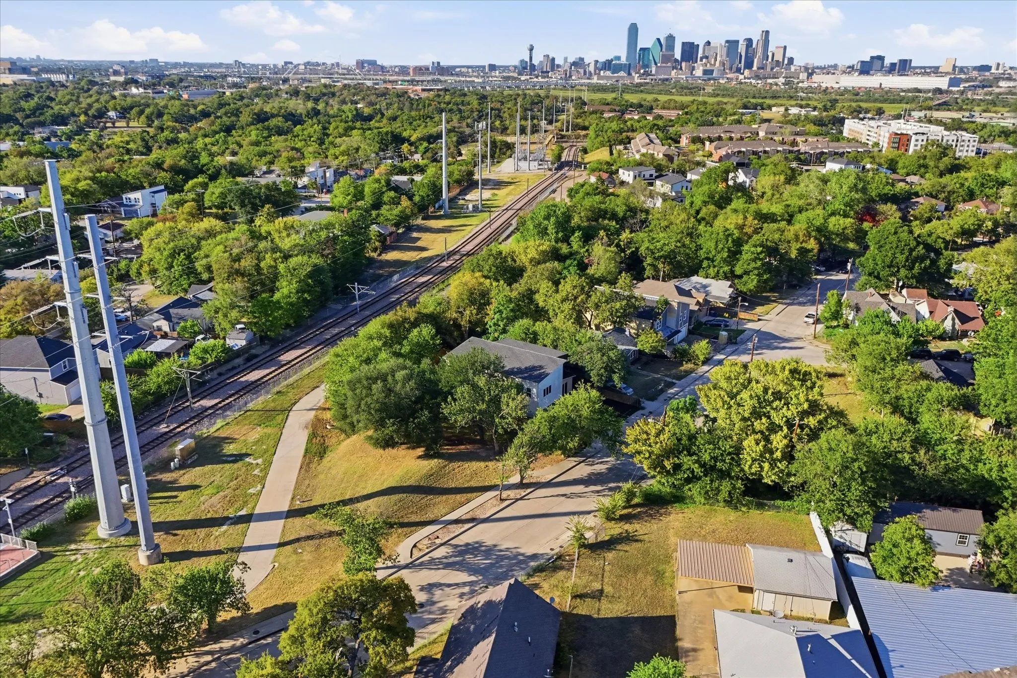 Suburban landscape with significant tree canopy and residential properties