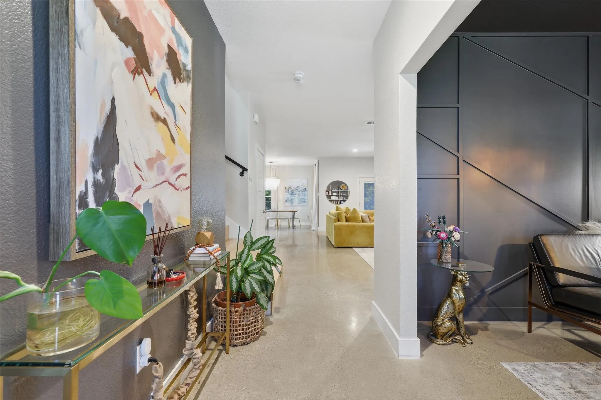 Smooth flooring, contemporary wall paneling, recessed lighting, and a modern stair railing