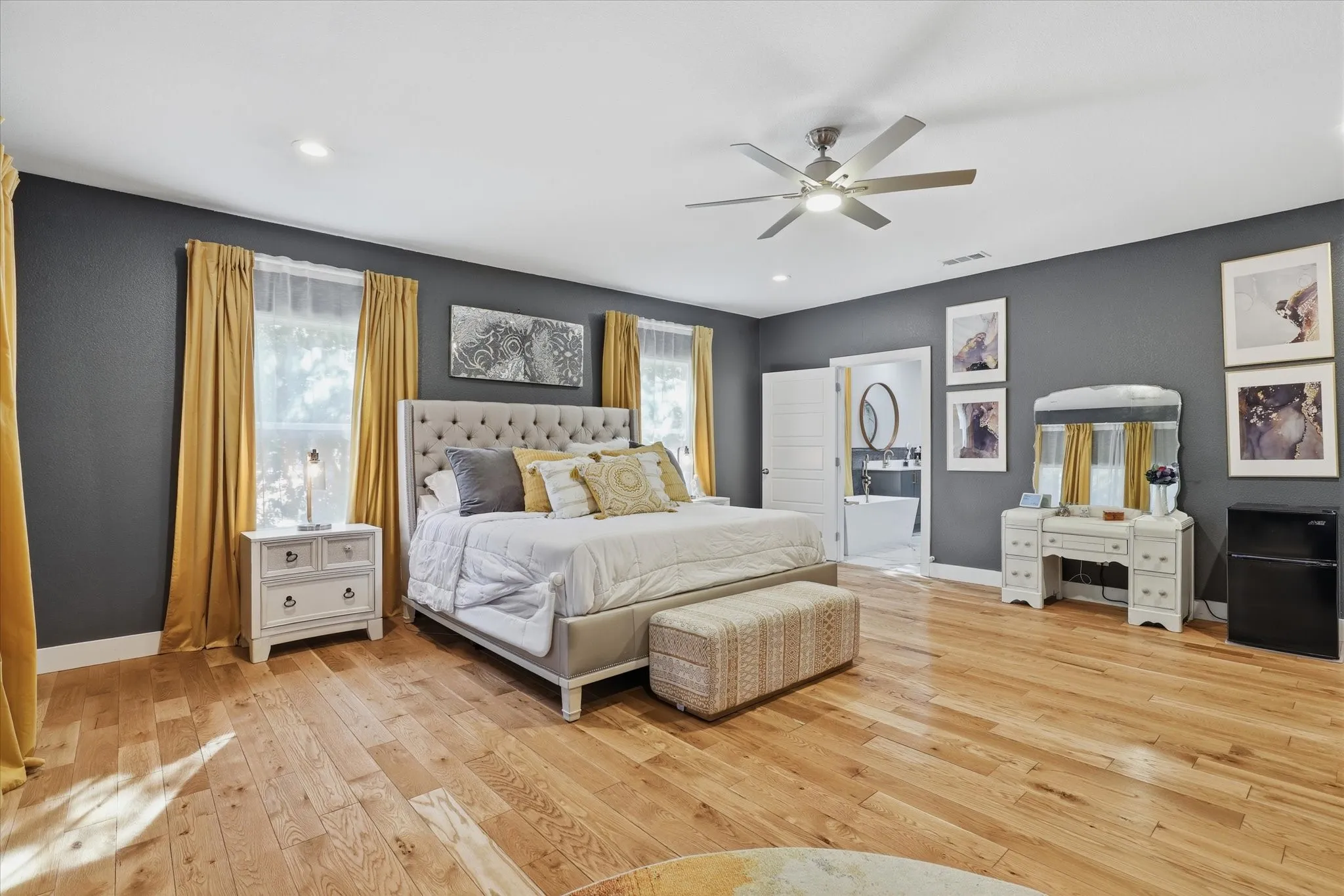 Spacious interior with wood-finish flooring, recessed lighting, and a ceiling fan