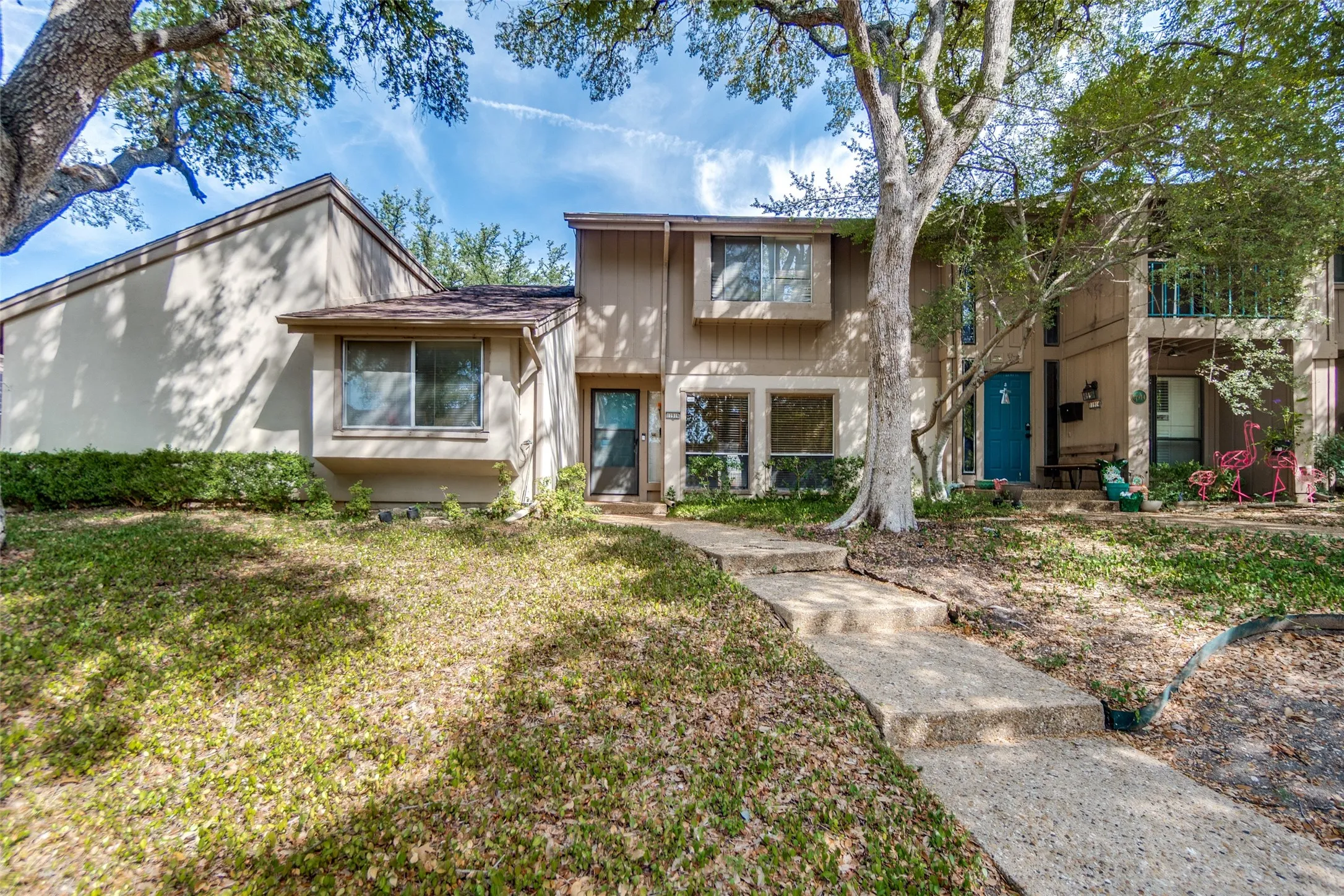 Multi-level exterior with a tan facade and a stepped concrete walkway