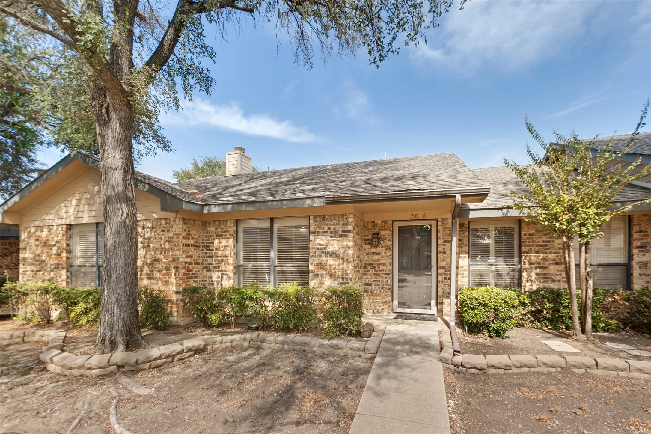Brick exterior featuring a gabled roof and front entry