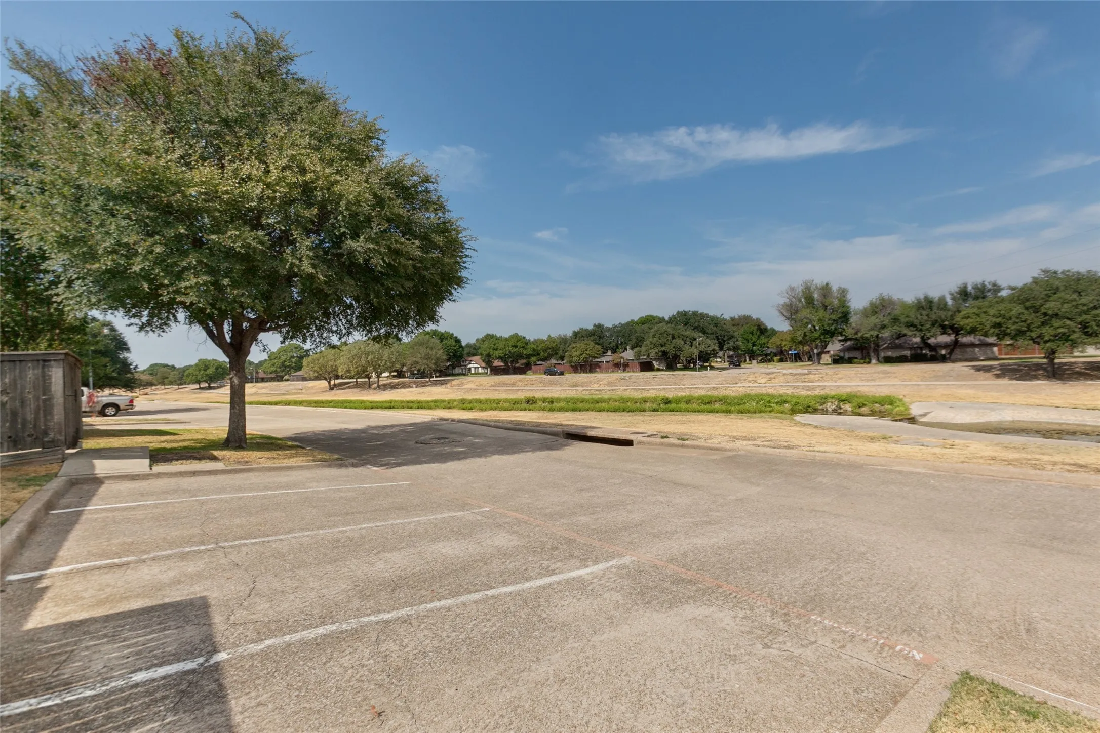 Paved parking area with marked spaces and curb delineation