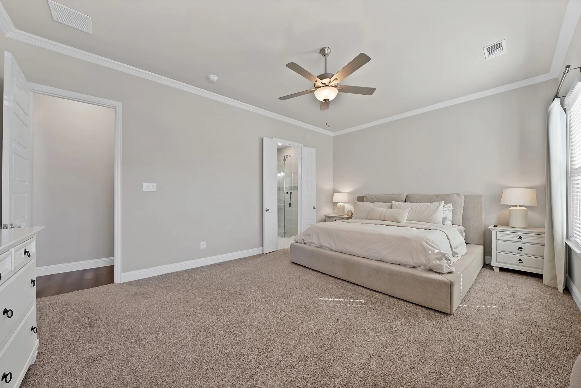 Carpeted flooring, vaulted ceiling, and crown molding