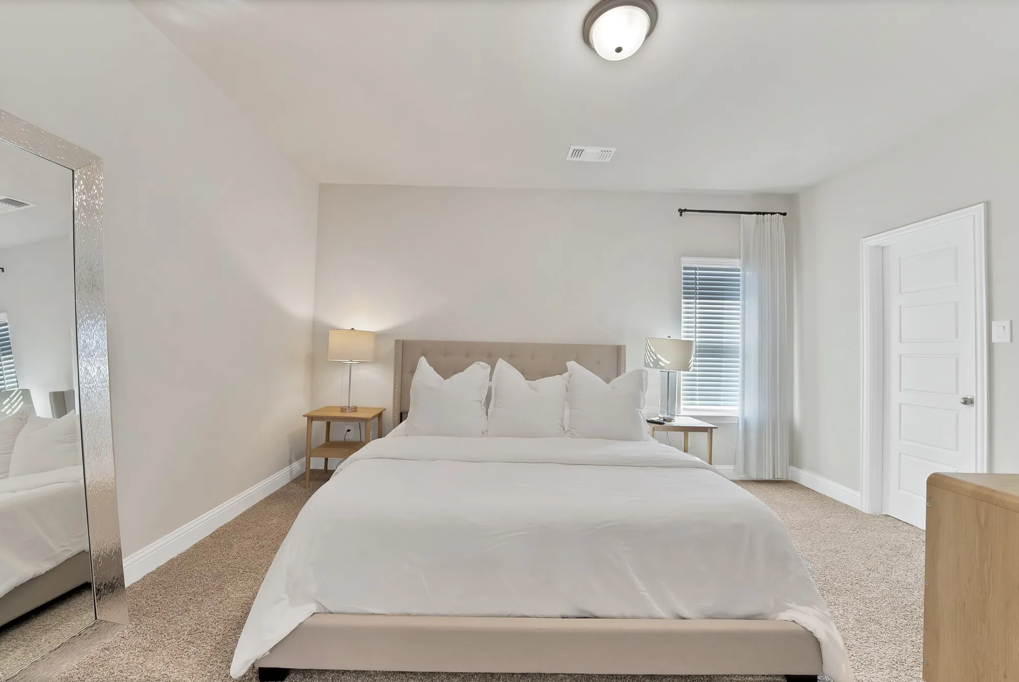 Neutral-toned walls complement plush carpeting