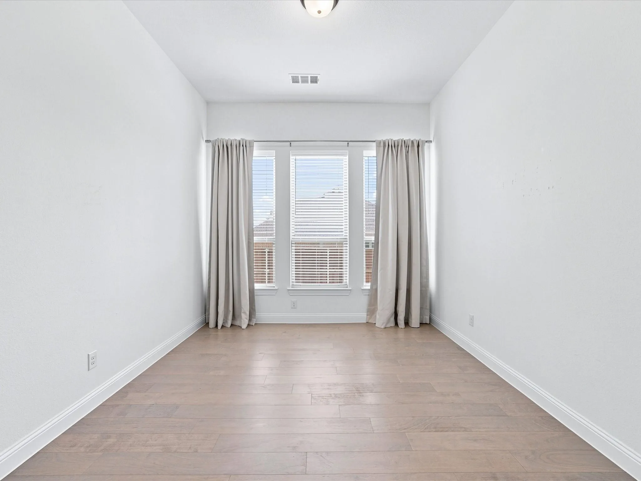 Wood-finish flooring with white walls and trim