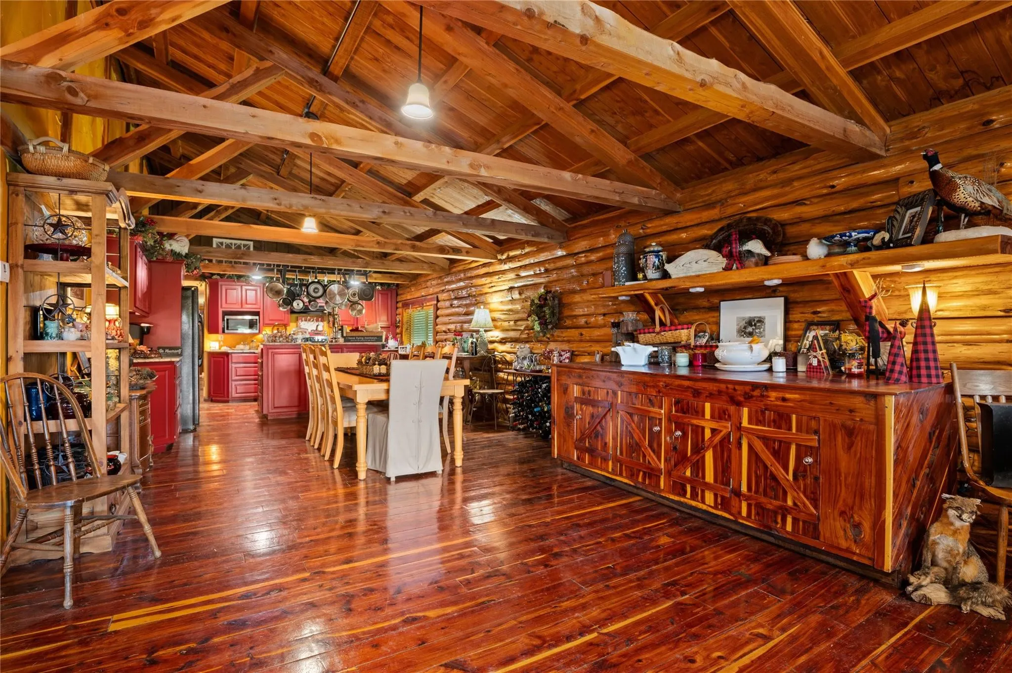 Exposed wooden beam ceiling, log wall construction, cedar flooring, and custom wood cabinetry.