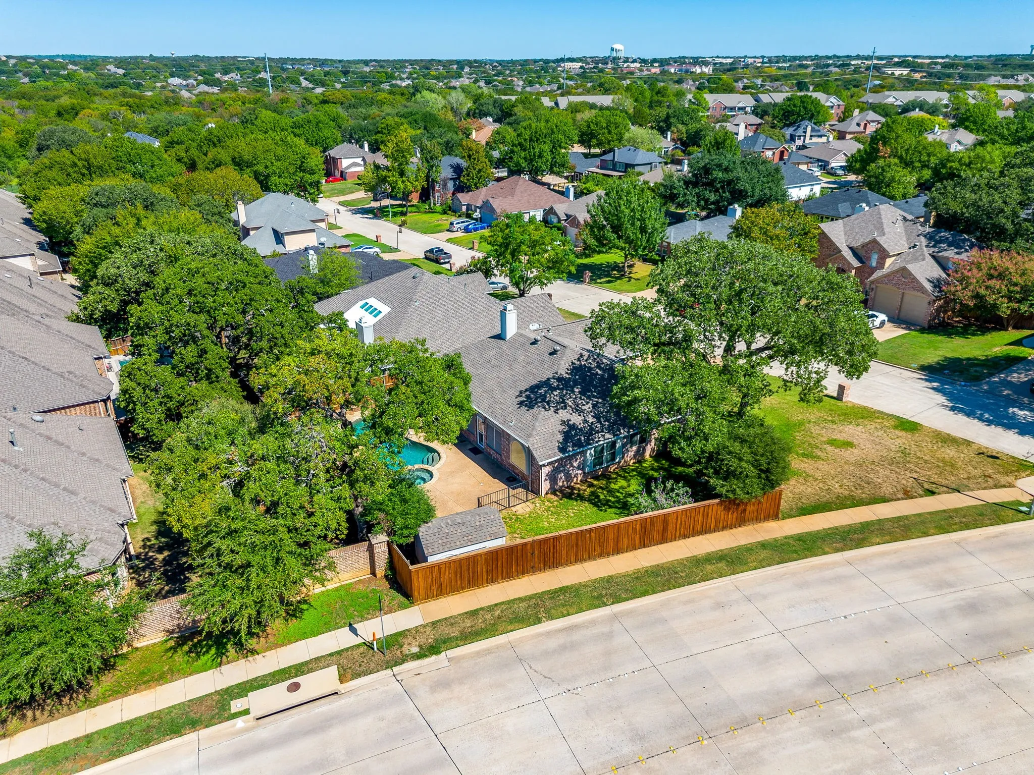 Swimming pool, integrated spa, privacy fencing, mature trees, and an established neighborhood setting